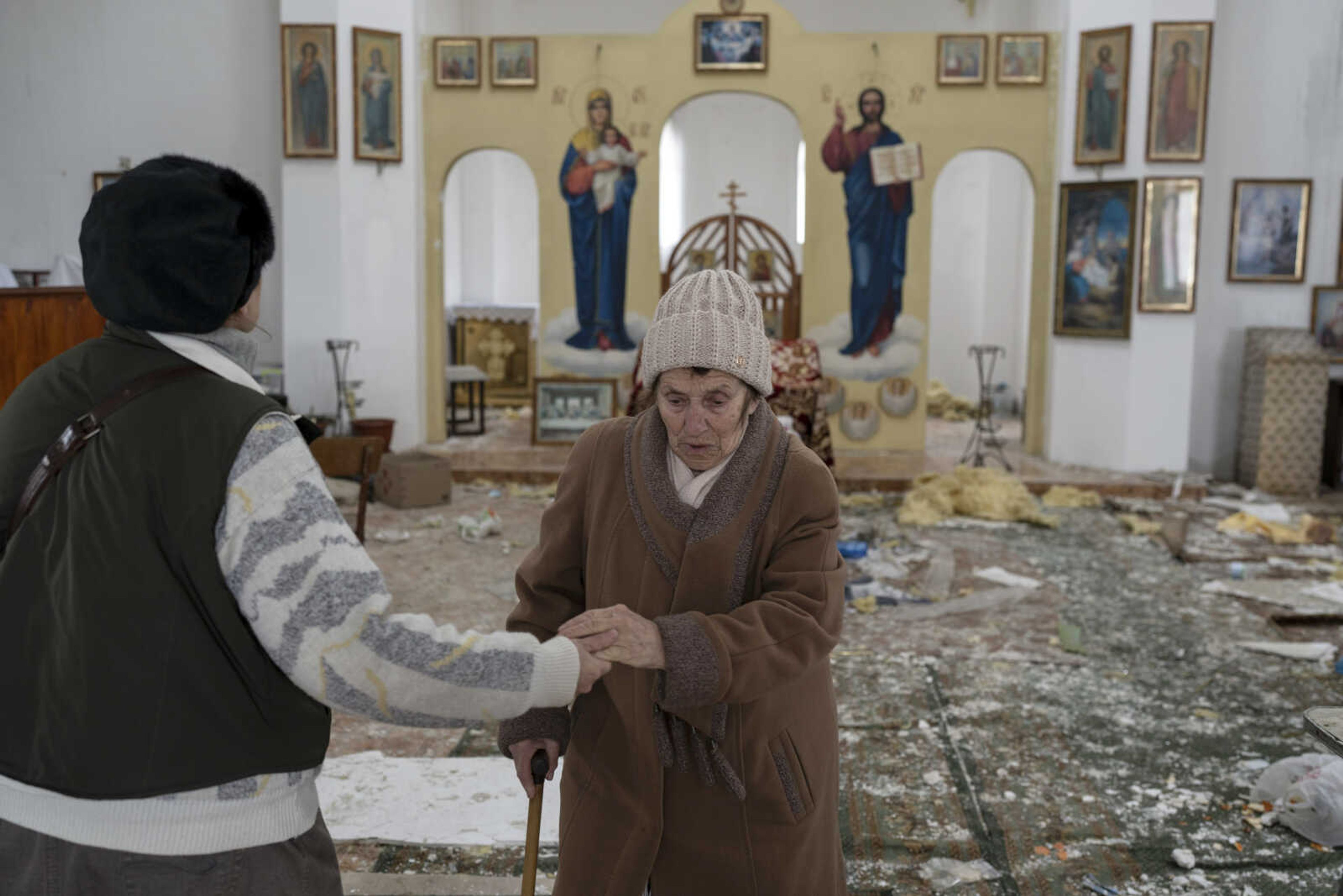 A woman reacts as she enters a damaged church following a Russian attack in the previous weeks, Sunday in the town of Makarov, in the Kyiv region, Ukraine. Since the beginning of the war, at least 59 spiritual sites, most are Orthodox churches, have been ruined or damaged, Ukrainian authorities said.