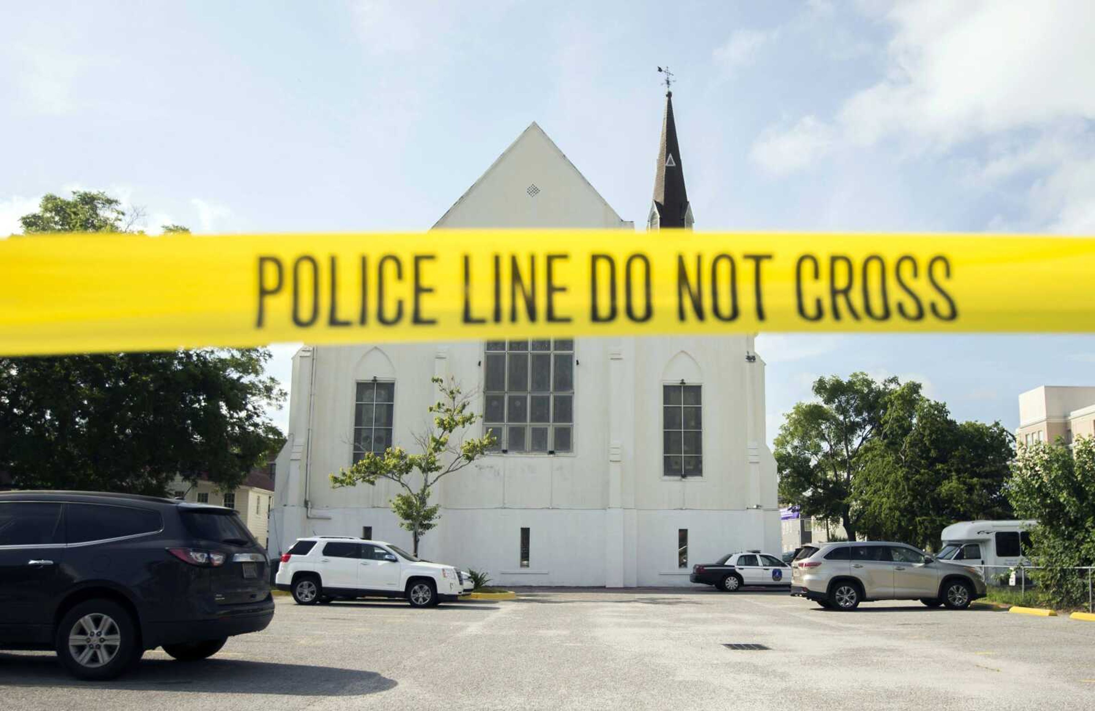 Police tape surrounds the parking lot behind the AME Emanuel Church as FBI forensic experts work the crime scene June 19, 2015, in Charleston, South Carolina.