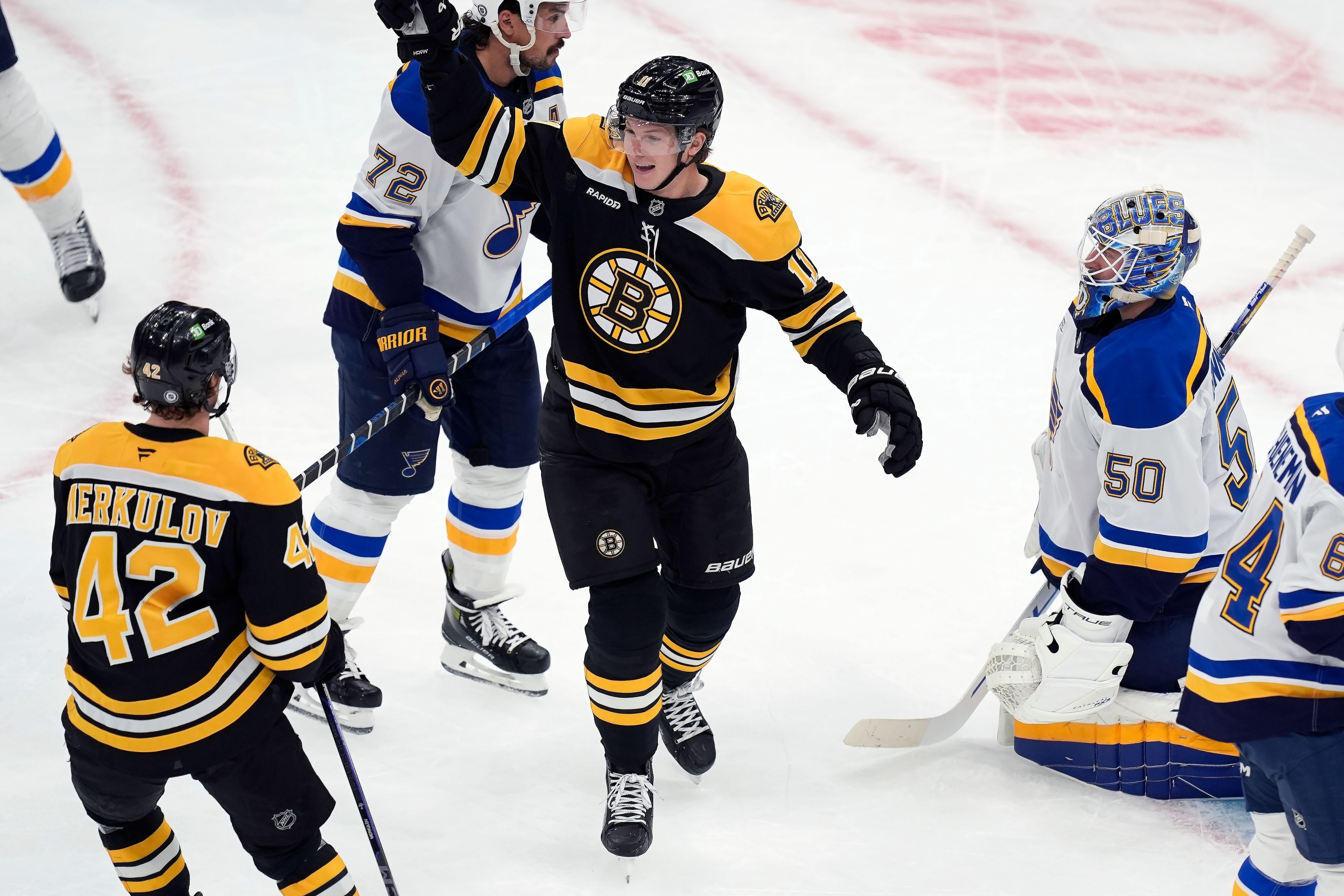 Boston Bruins' Trent Frederic (11) celebrates his second goal of the first period past St. Louis Blues' Jordan Binnington (50) during an NHL hockey game, Saturday, Nov. 16, 2024, in Boston. (AP Photo/Michael Dwyer)