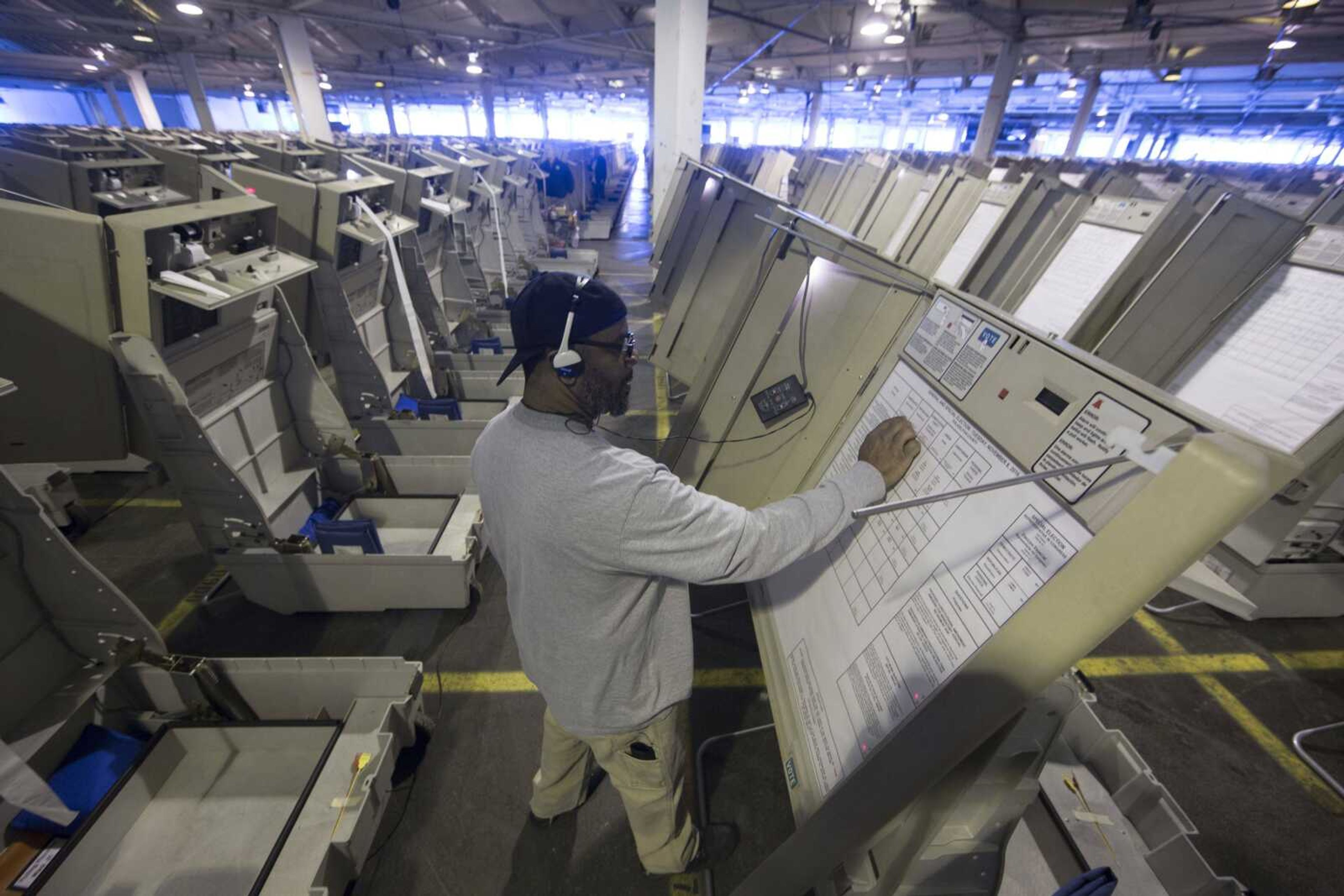 A technician works Oct. 14 to prepare voting machines to be used in the upcoming election in Philadelphia. These paperless digital voting machines, used by roughly one in five U.S. voters last month, present one of the most glaring dangers to the security of the rickety, underfunded U.S. election system. Like many electronic voting machines, they are vulnerable to hacking. But other machines typically leave a paper trail that could be manually checked.