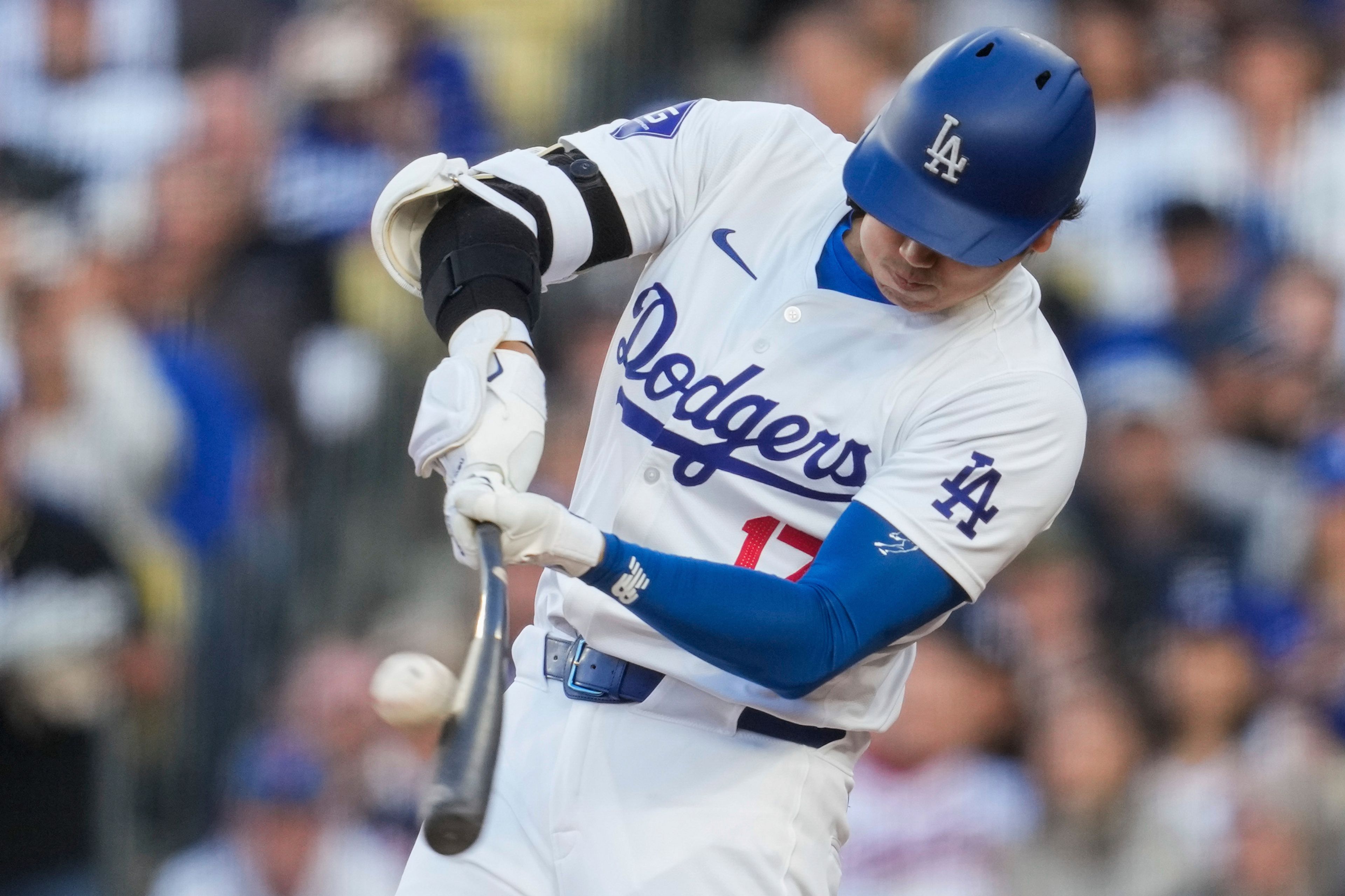 Los Angeles Dodgers designated hitter Shohei Ohtani (17) hits a home run during the third inning of a baseball game against the Atlanta Braves in Los Angeles, Saturday, May 4, 2024. (AP Photo/Ashley Landis)