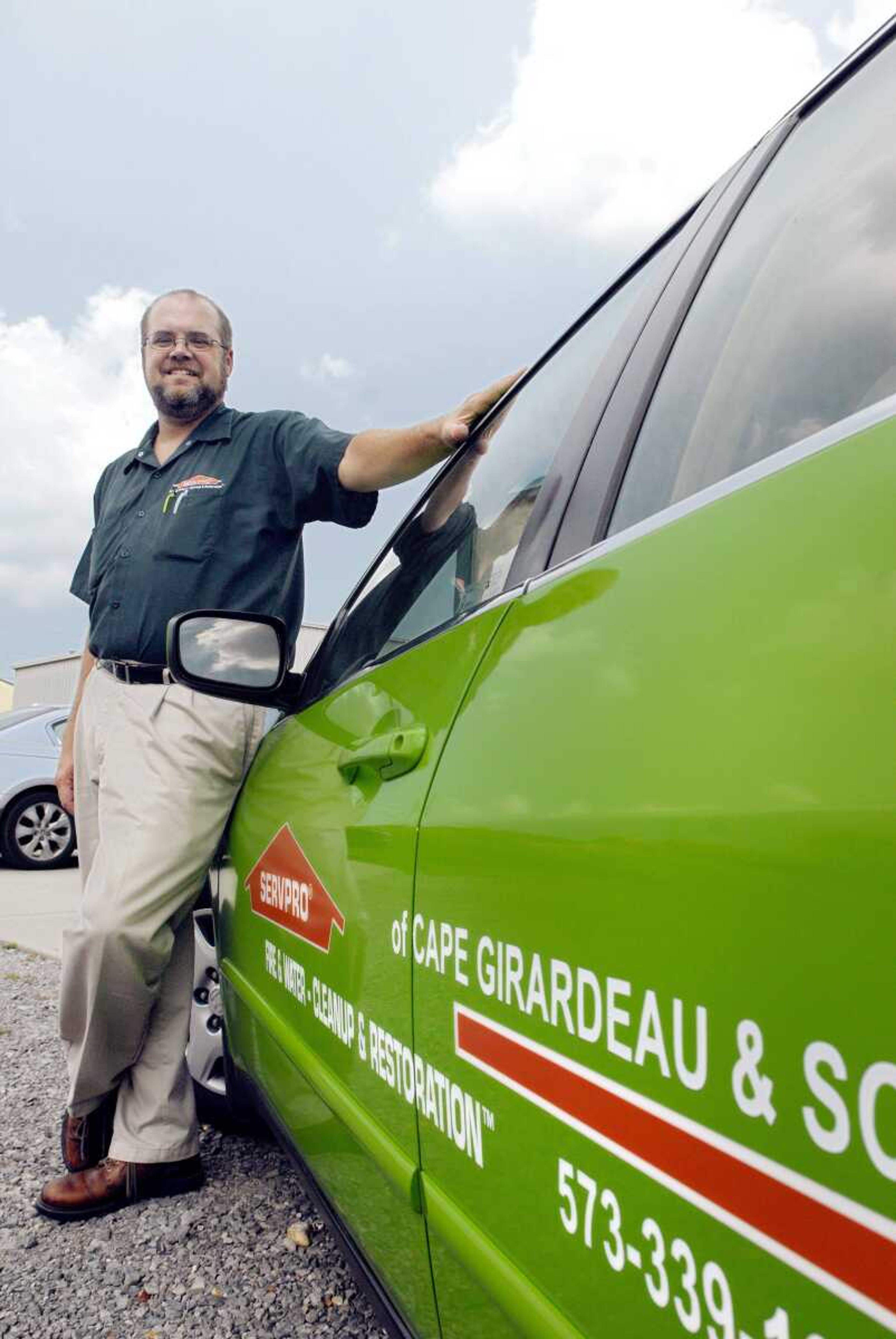 Rob Stephens poses with the "green machine" outside of the Cape Girardeau ServPro office Thursday. (Laura Simon)