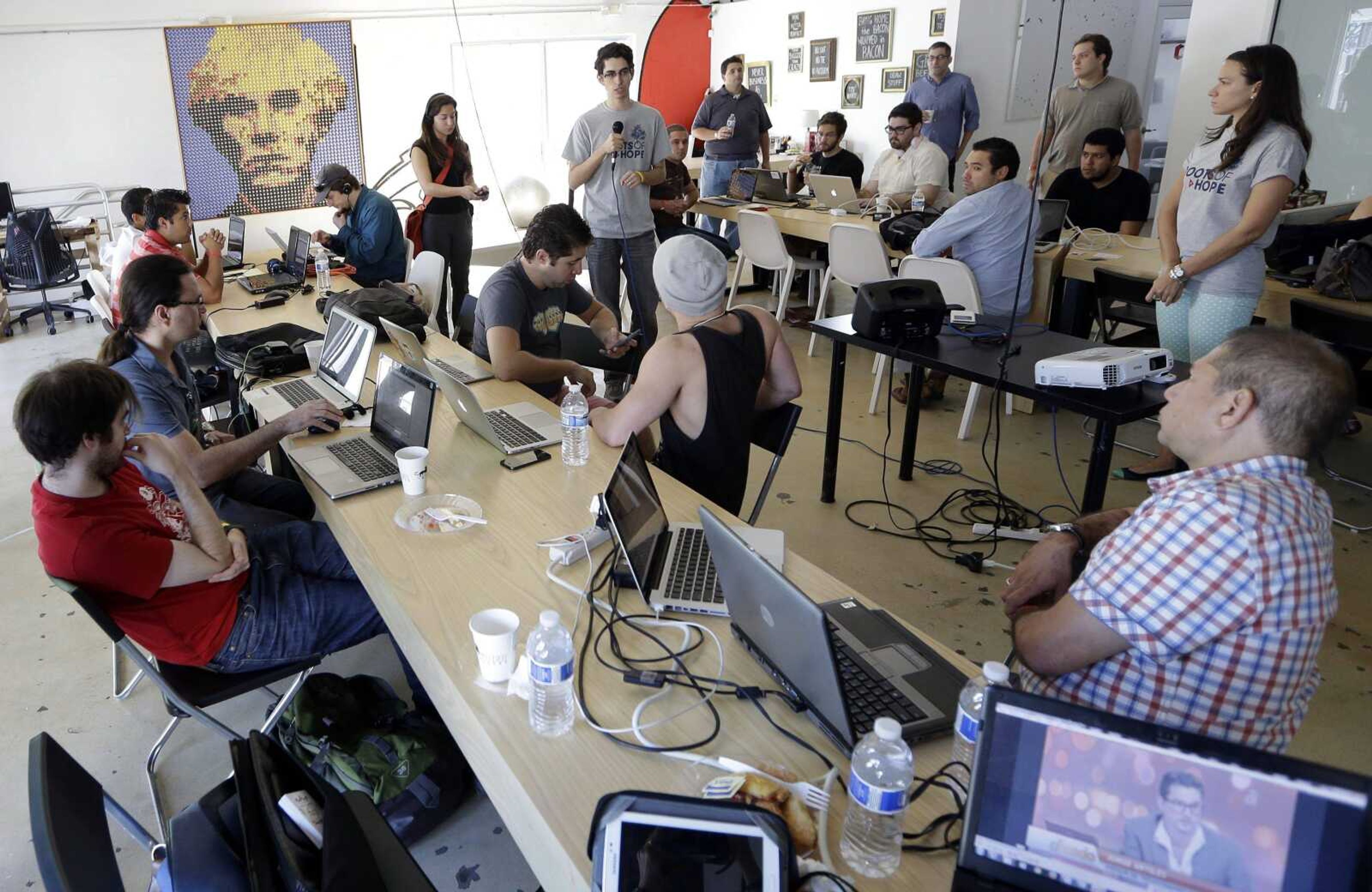 Raul Moas, center rear, executive director of the not-for-profit organization Roots of Hope, addresses a group Feb. 1 during a &#8220;Hackathon for Cuba&#8221; event. A group of technology experts gathered to come up with ways to use their hacking ability to improve Internet access and information in Cuba, including &#8220;Cuba Twitter.&#8221; (Lynne Sladky ~ Associated Press)