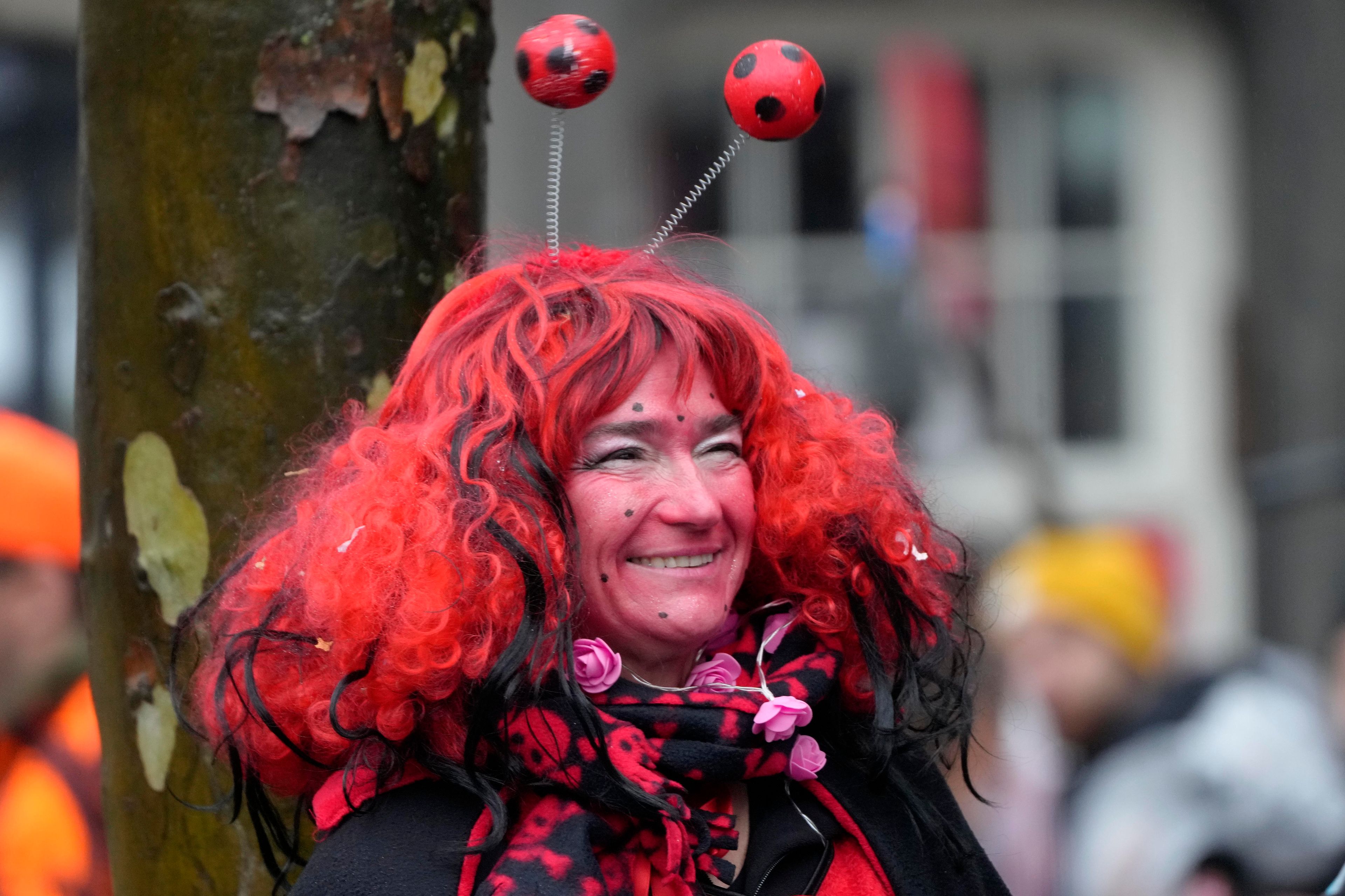 A costumed reveler smiles at the central Heumarkt while tens of thousands of carnival fools take to the streets of Cologne, Germany, on Monday, November 11, 2024, heralding the official start of the carnival season. (AP Photo/Martin Meissner)