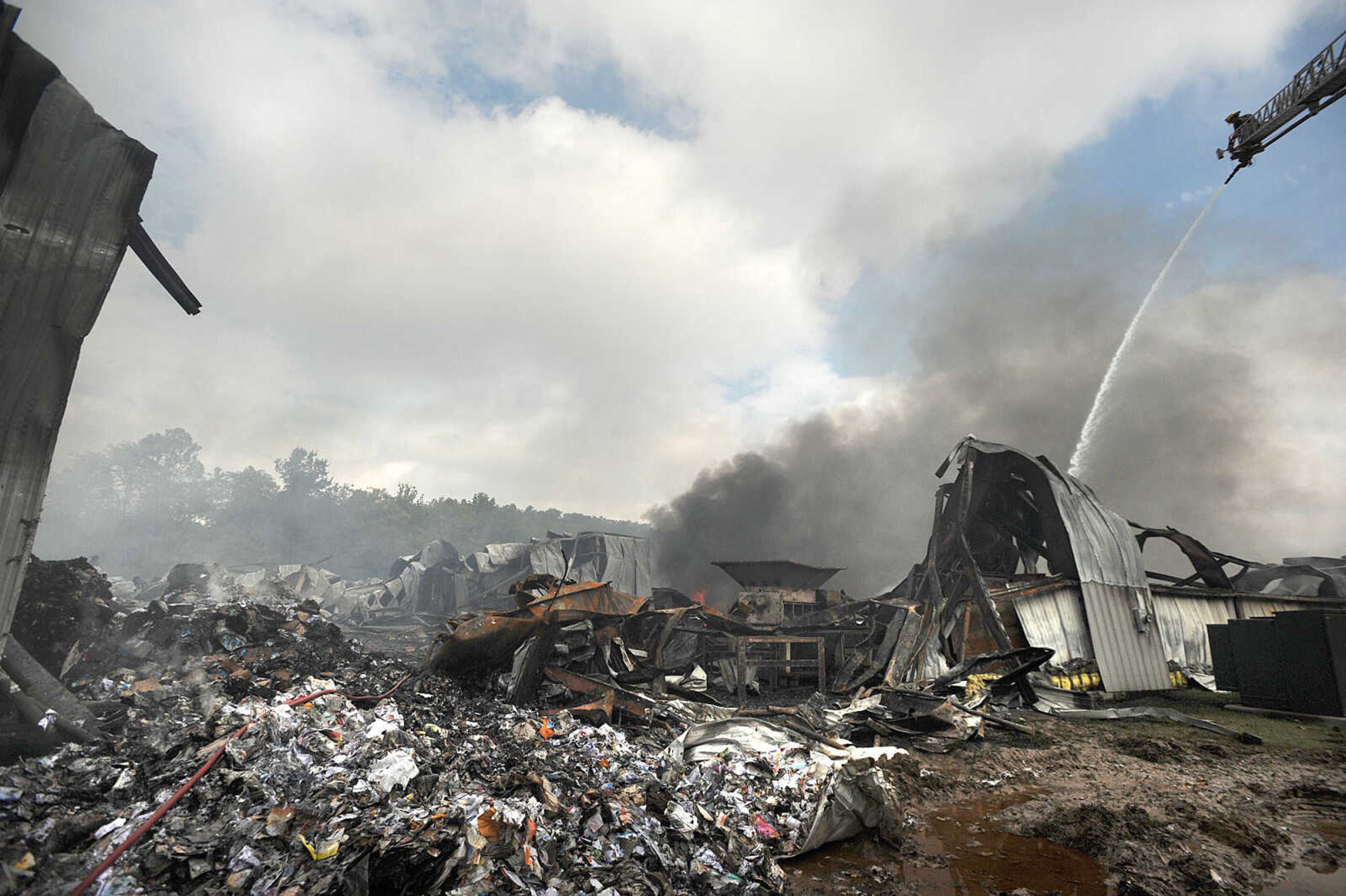 LAURA SIMON ~ lsimon@semissourian.com

Jamie Hann with the Cape Girardeau Fire Department showers the smoldering remnants of the Missouri Plastics plant Friday morning, Oct. 4, 2013, in Jackson. The approximately 100,00-square-foot recycling plant caught fire around 10 p.m. Thursday. Every fire department in Cape Girardeau County was dispatched to battle the blaze.