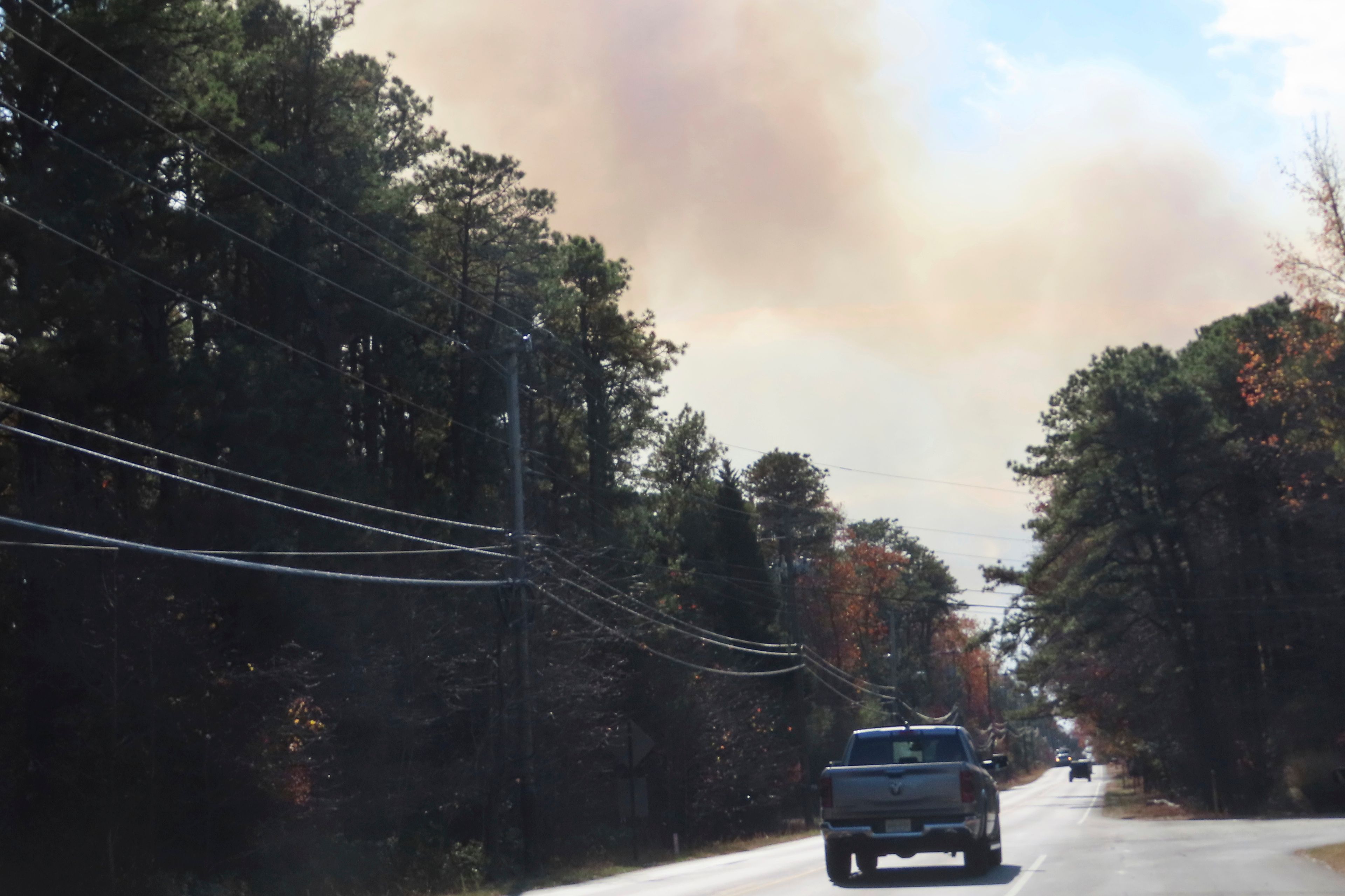 Smoke from a forest fire rises above the trees in Evesham, N.J. on Thursday, Nov. 7, 2024, when firefighters said conditions were the driest in New Jersey in nearly 120 years. (AP Photo/Wayne Parry)