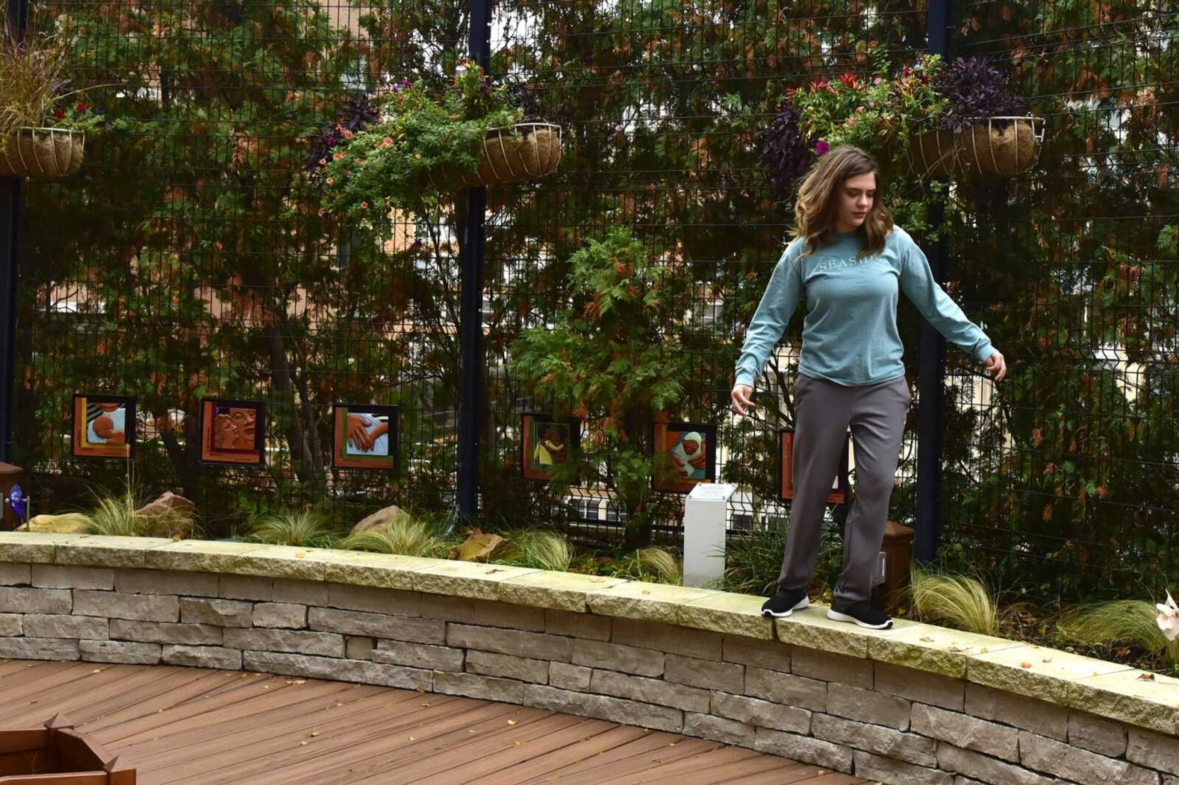 Allee McKee maintains her balance while running atop a ledge Oct. 29 in The Olson Family Garden at St. Louis Children's Hospital.