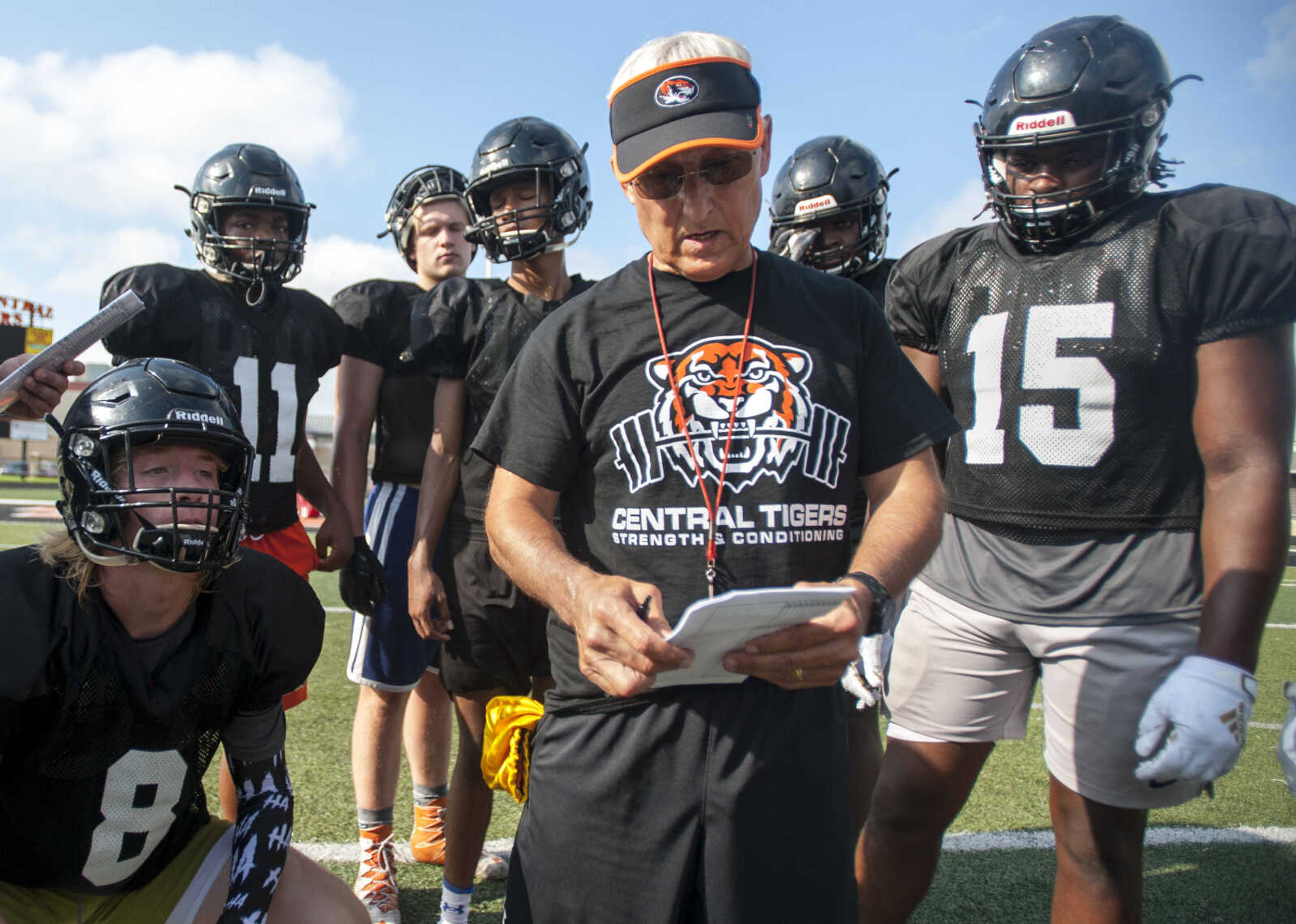 Cape Central football players around head coach Kent Gibbs as he reviews a play during a summer workout Tuesday, July 30, 2019, at Cape Central High School in Cape Girardeau.