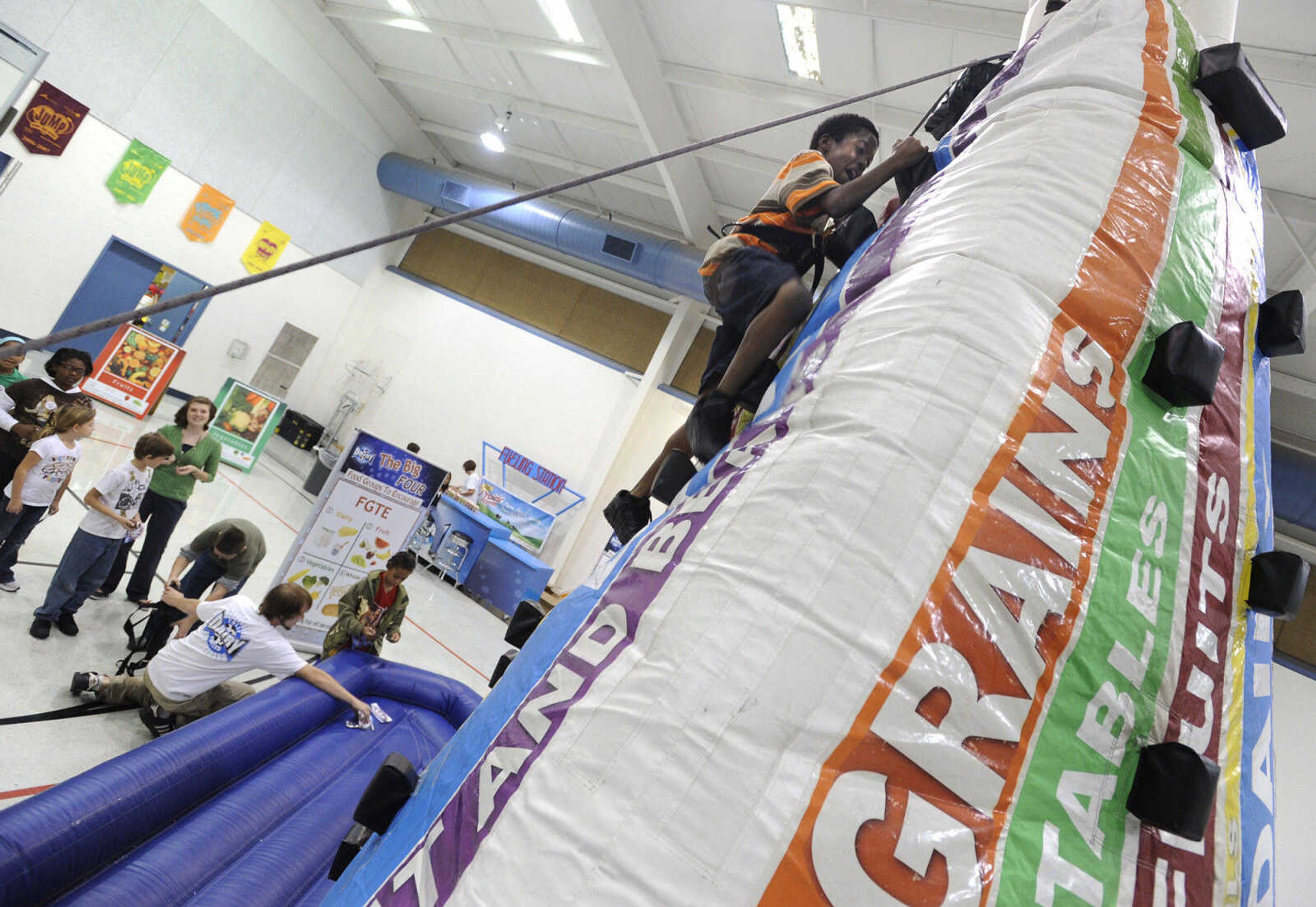 FRED LYNCH ~ flynch@semissourian.com
Tyrese McClinton climbs the inflatable Food Pyramid, one of the stations on the Dairy Fully Fueled Tour, Tuesday, Nov. 9, 2010 at Franklin Elementary School.