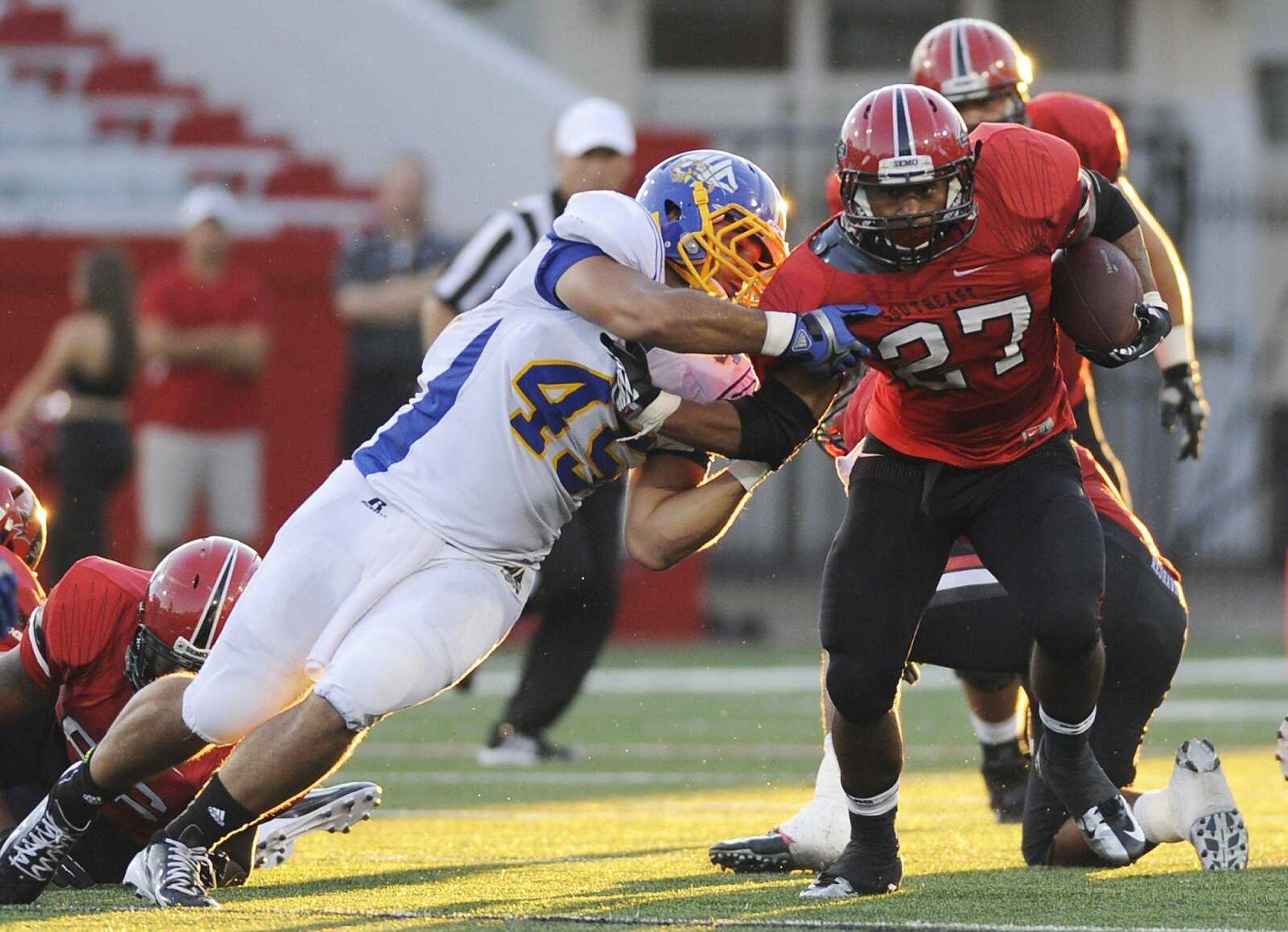 Southeast Missouri State running back Levi Terrell tries to break free from Mars Hill linebacker Rudy Cabral during the Redhawks&#8217; 30-18 win over the Lions on Saturday at Houck Stadium. (ADAM VOGLER)