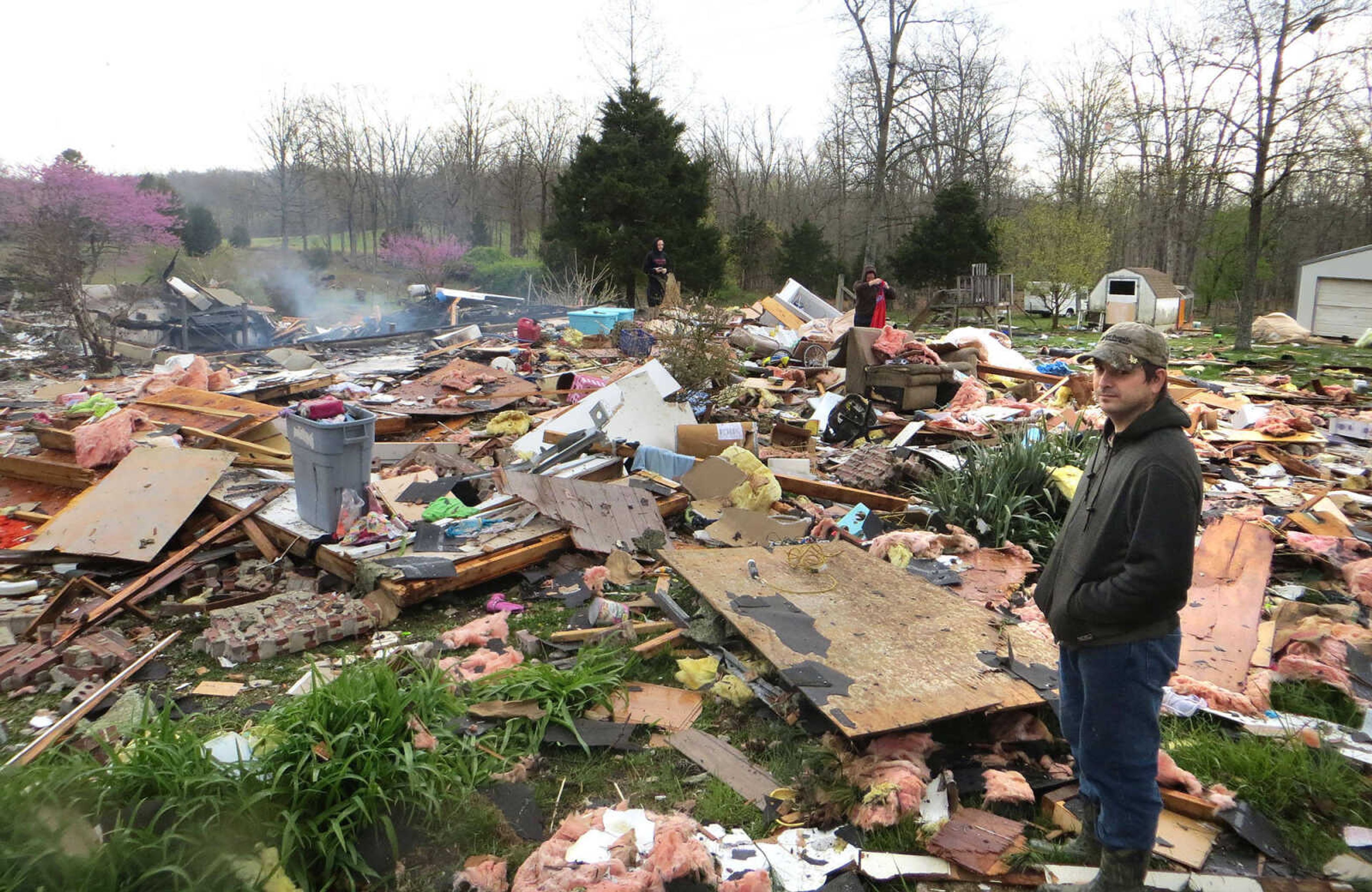 Isaac Wittenborn looks over the remains of his family's home after it was destroyed by an explosion Saturday night. A propane gas leak is suspected. (Tyler Graef)