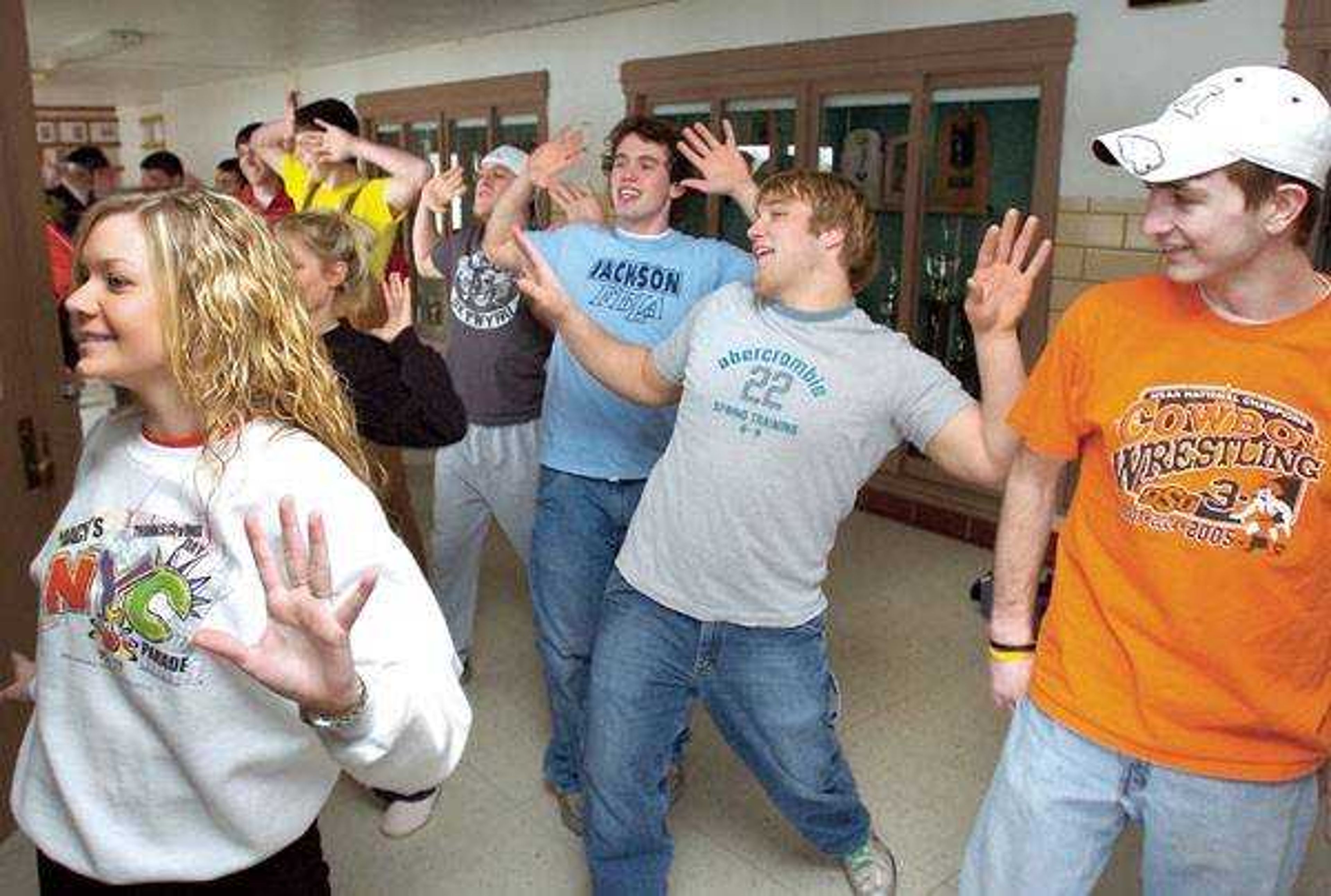 Laci Thorne demonstrated dance moves Monday for some Jackson High School boys who will compete in the Mr. JHS contest, including from right, Russell Brown, Kamden Rampley, Logan Bollinger and Anthony Werner. (Fred Lynch)