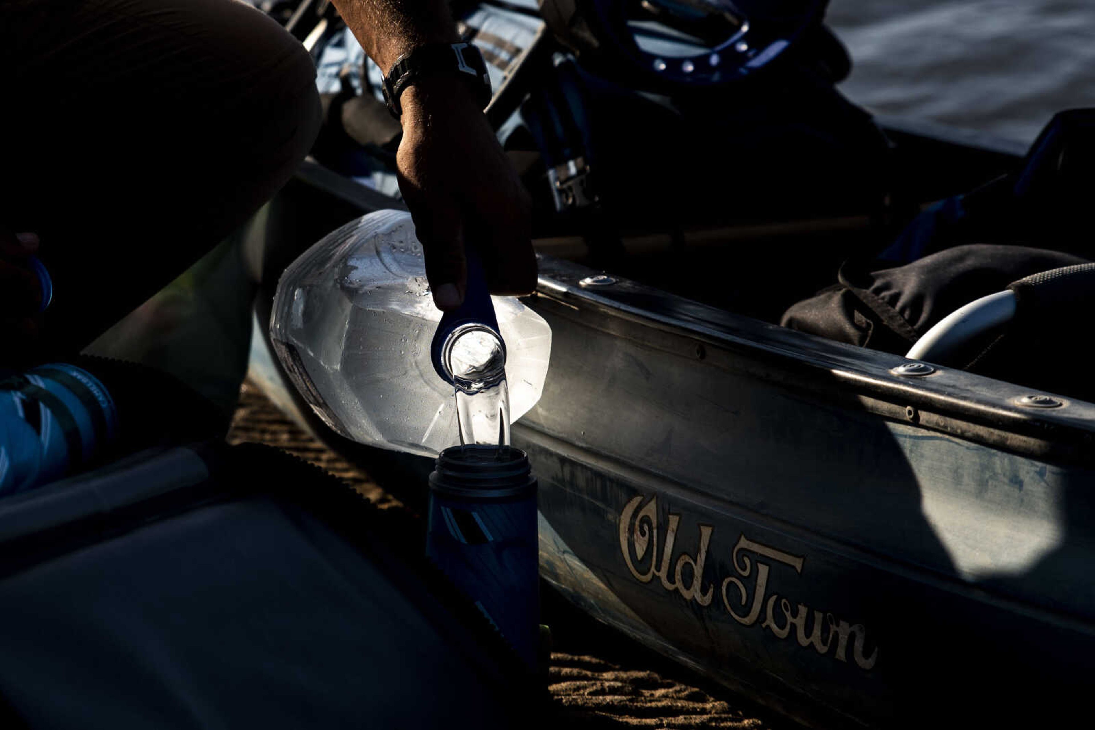 Ryan Webb pours water into his thermos while preparing his kayak at the loading dock at Red Star Dock before hitting the water again during an excursion down the Mississippi River Tuesday, Aug. 28, 2018 in Cape Girardeau. Webb, along with Rick Baine and Matt Roy (not pictured), are making their way down the Mississippi River as part of the Warrior Paddle Expedition, starting at the source of the Mississippi River, Lake Itsaca, Minnesota, and ending in the Gulf of Mexico.