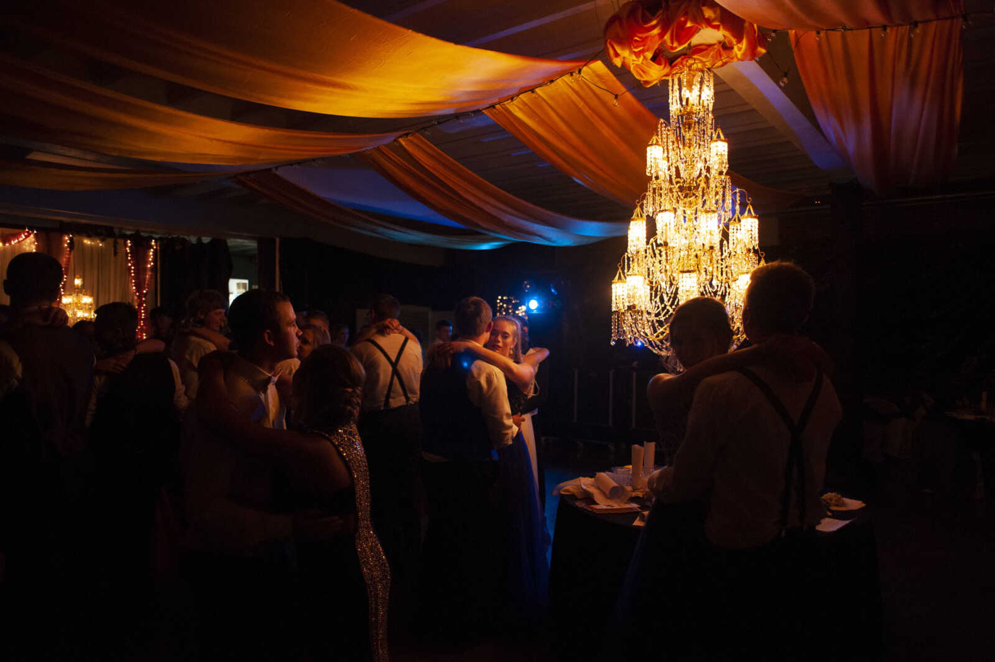 Leopold senior Grace Seabaugh, center, dances with Meadow Heights junior Jacob Elfrink during Leopold High School's "Masquerade at Midnight" prom Saturday, April 27, 2019, in Leopold.