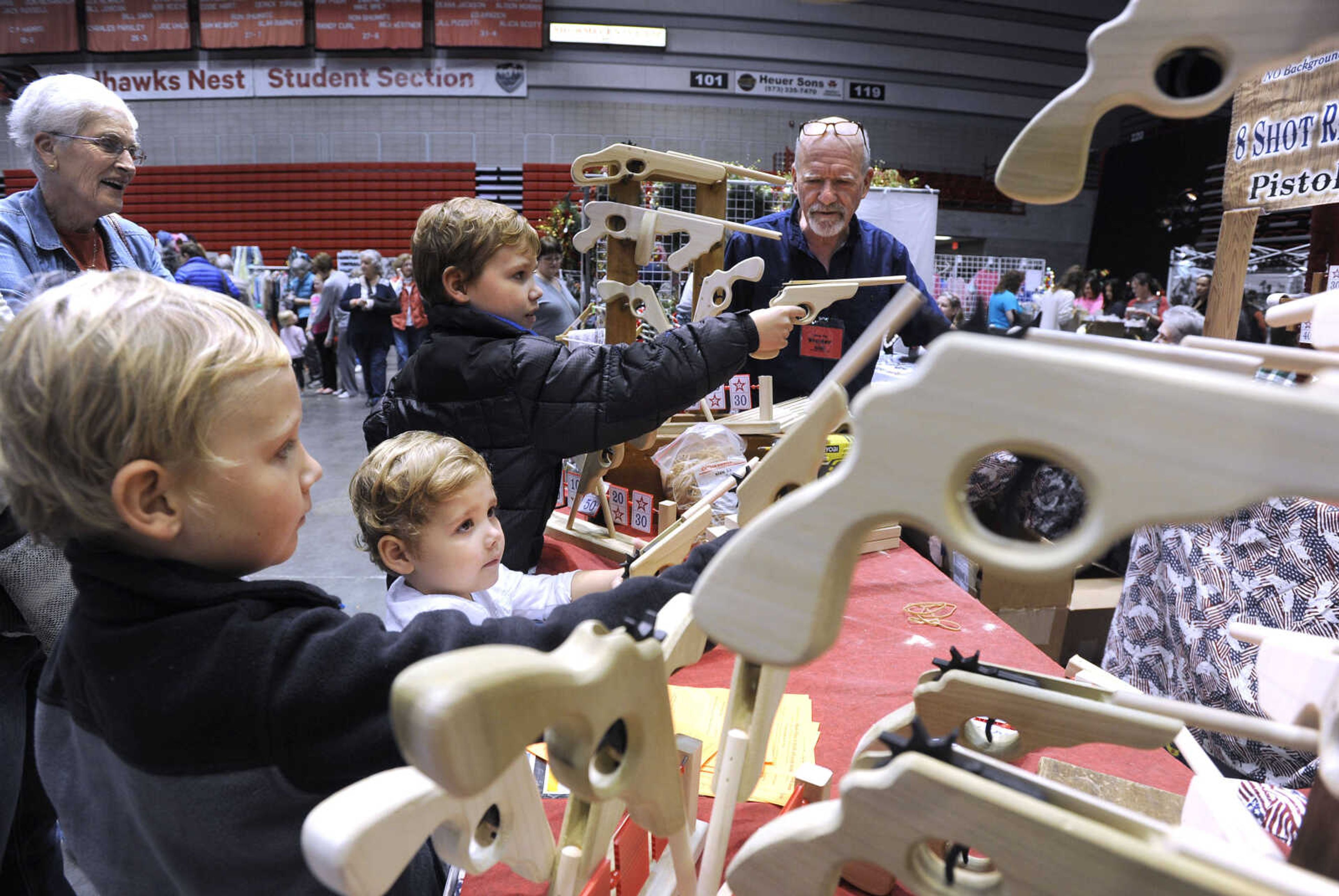 FRED LYNCH ~ flynch@semissourian.com
Josh Parker, left, Brody Parker and Henry Parker of Jackson test rubber-band pistols Saturday, Nov. 18, 2017 at Herb Decker's booth at the Christmas Arts & Crafts Extravaganza in the Show Me Center.