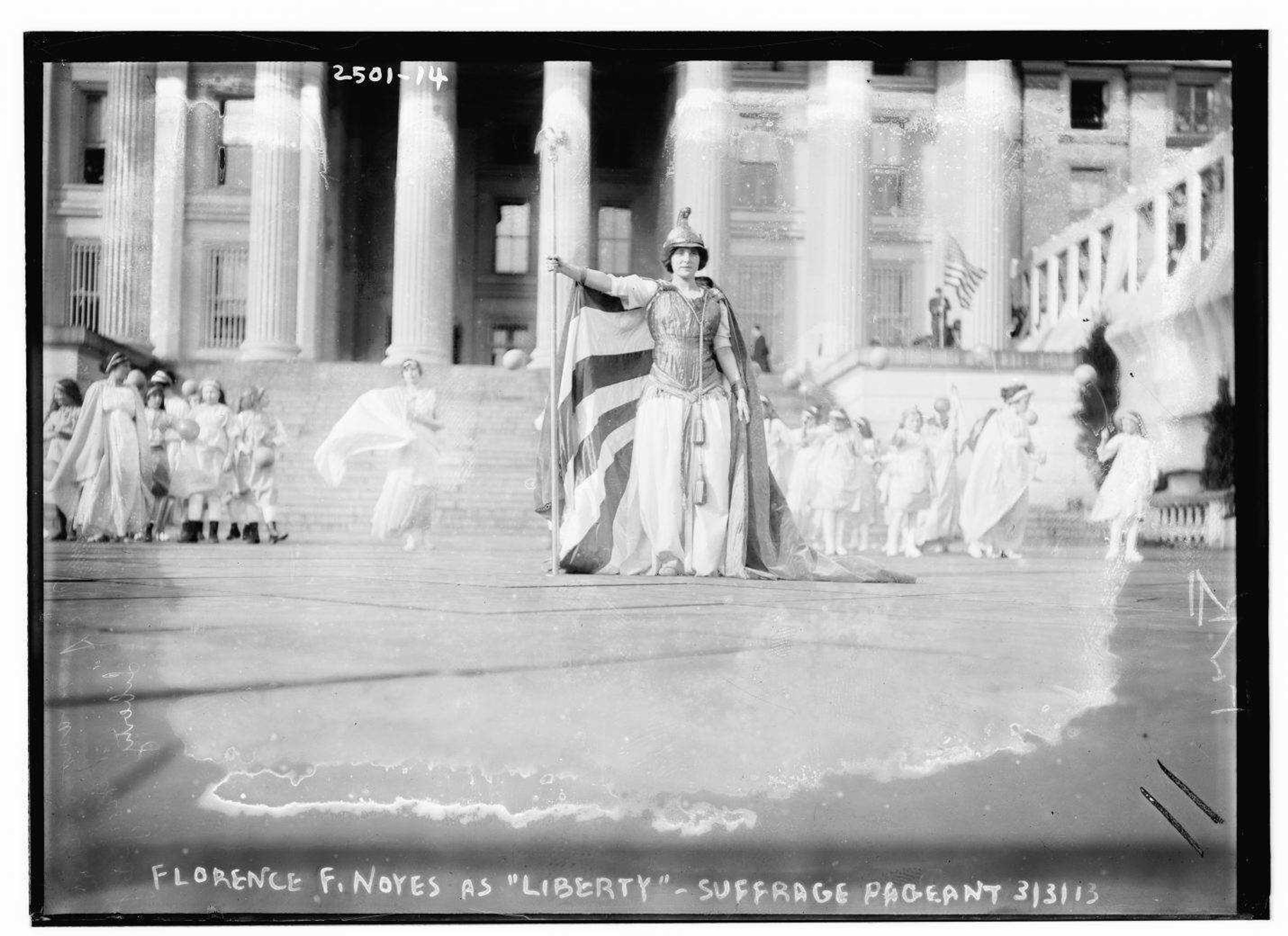 German actress Hedwig Reicher, wearing the costume of "Columbia," stands in front of the Treasury Building during a women suffragist rally in 1913 in Washington.