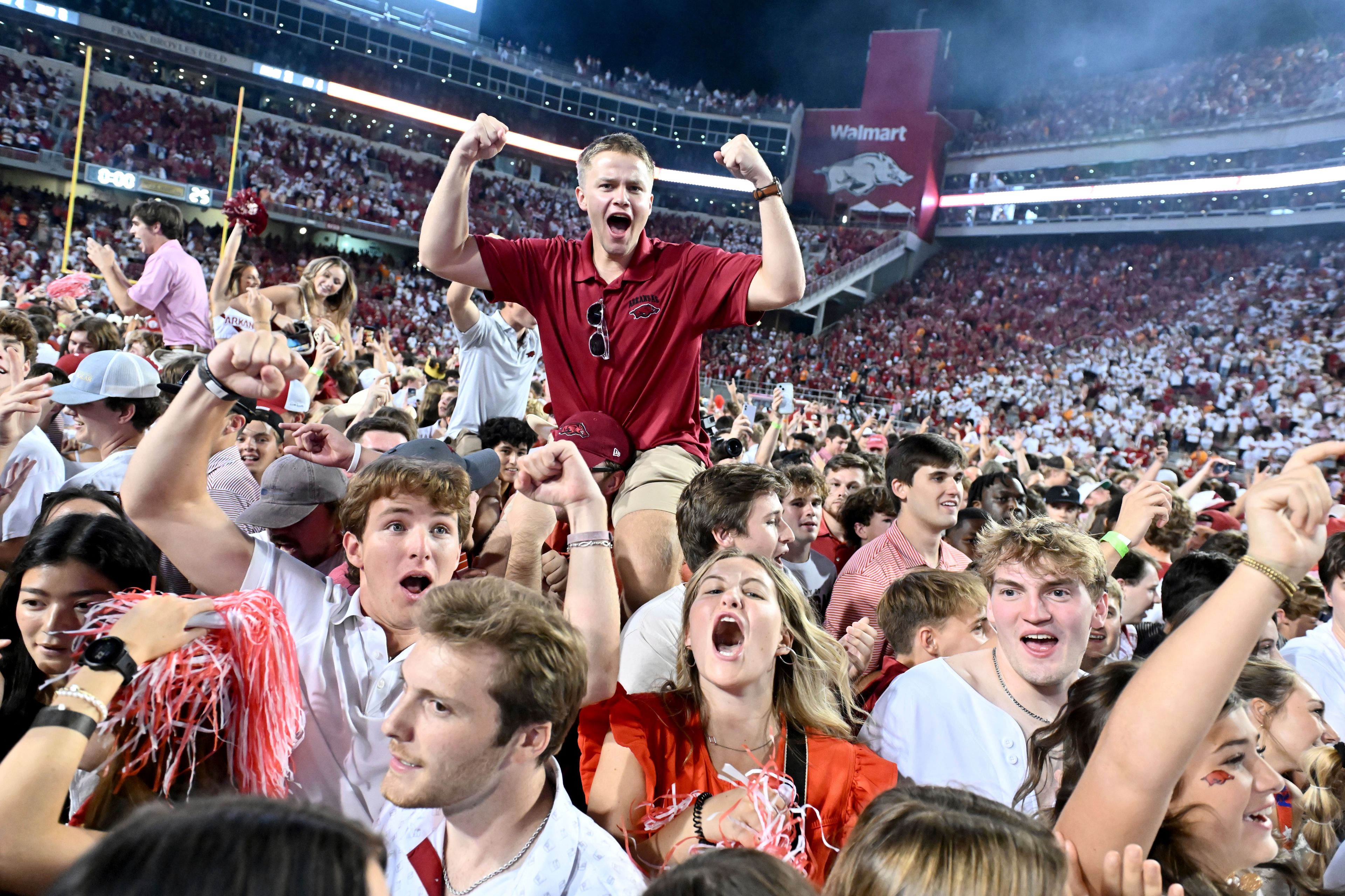 Arkansas fans celebrate after Arkansas upsets Tennessee 19-14 during an NCAA college football game, Saturday, Oct. 5, 2024, in Fayetteville, Ark. (AP Photo/Michael Woods)