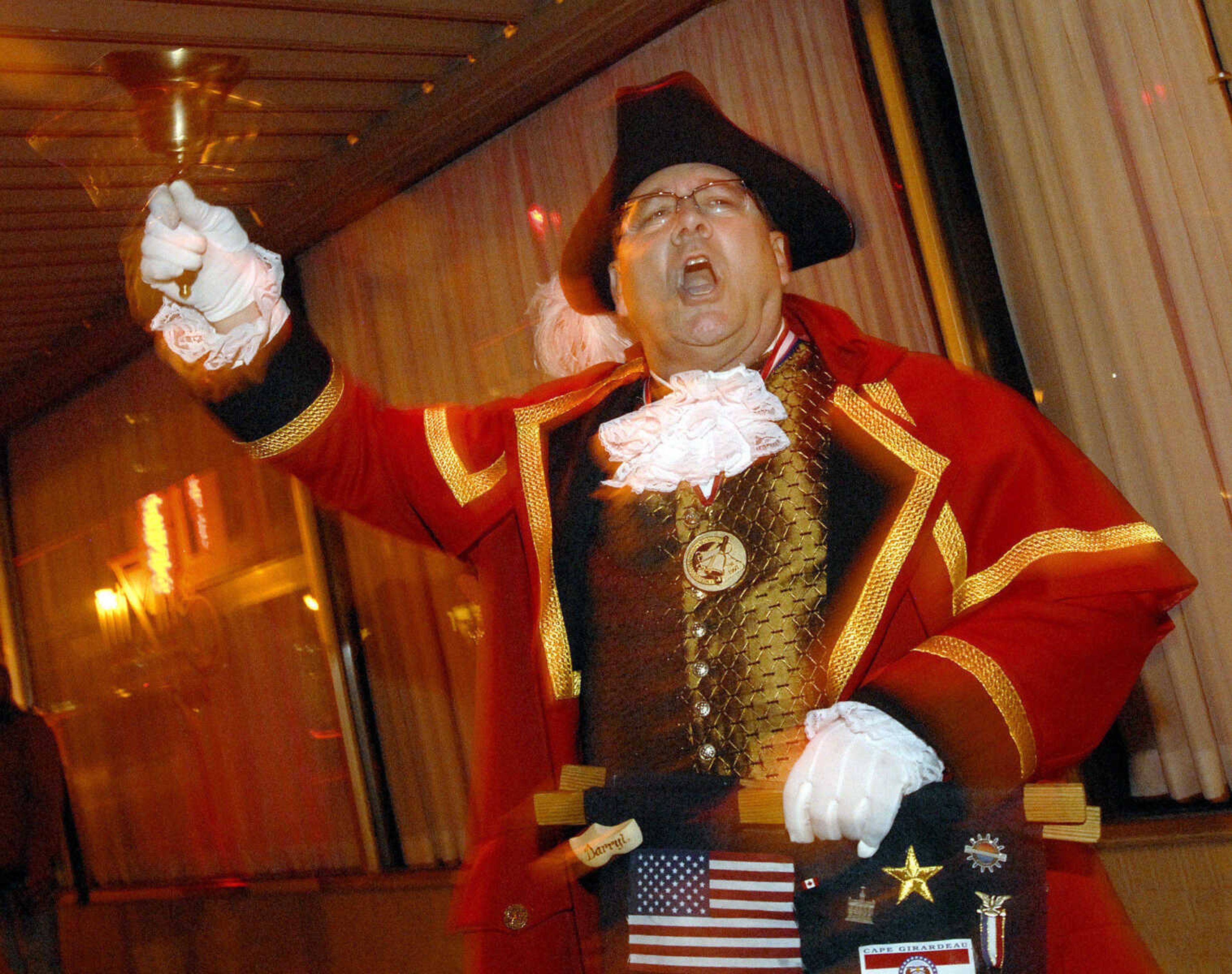 LAURA SIMON ~ lsimon@semissourian.com
Town crier Darryl Morgan rings his bell at the corner of Main and Independence Friday, Dec. 2, 2011 during Old Town Cape's annual Downtown Christmas Open House.