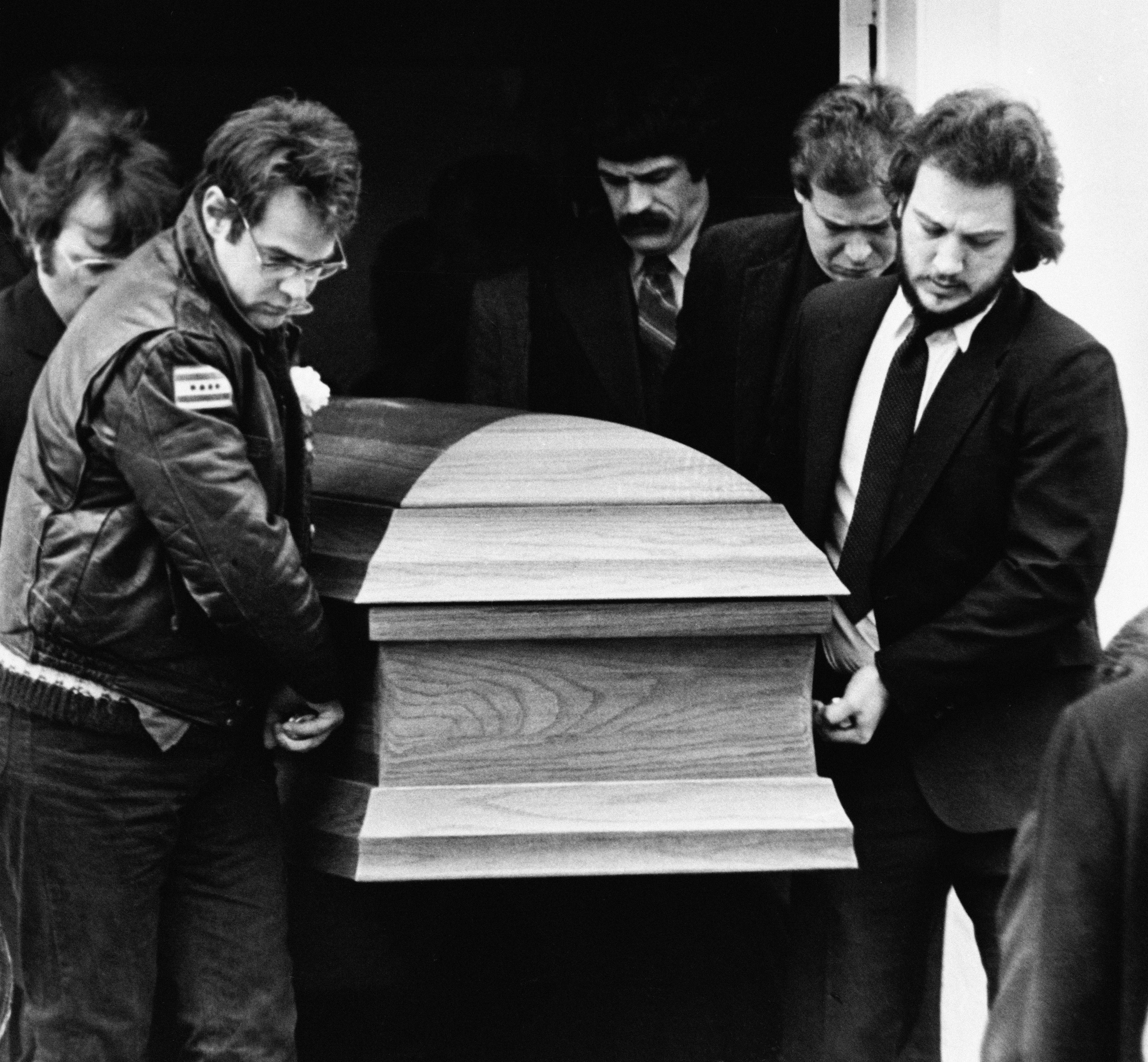 FILE - The coffin for actor John Belushi is carried out of the Congregational Church by pallbearers Dan Aykroyd, left, and Belushi's brother Jim Belushi, right, following funeral services in West Tinsbury, Mass., on March 9, 1982. Belushi died March 5, at 33 after overdosing at the Chateau Marmont in Los Angeles. (AP Photo/Dave Tenenbaum, File)