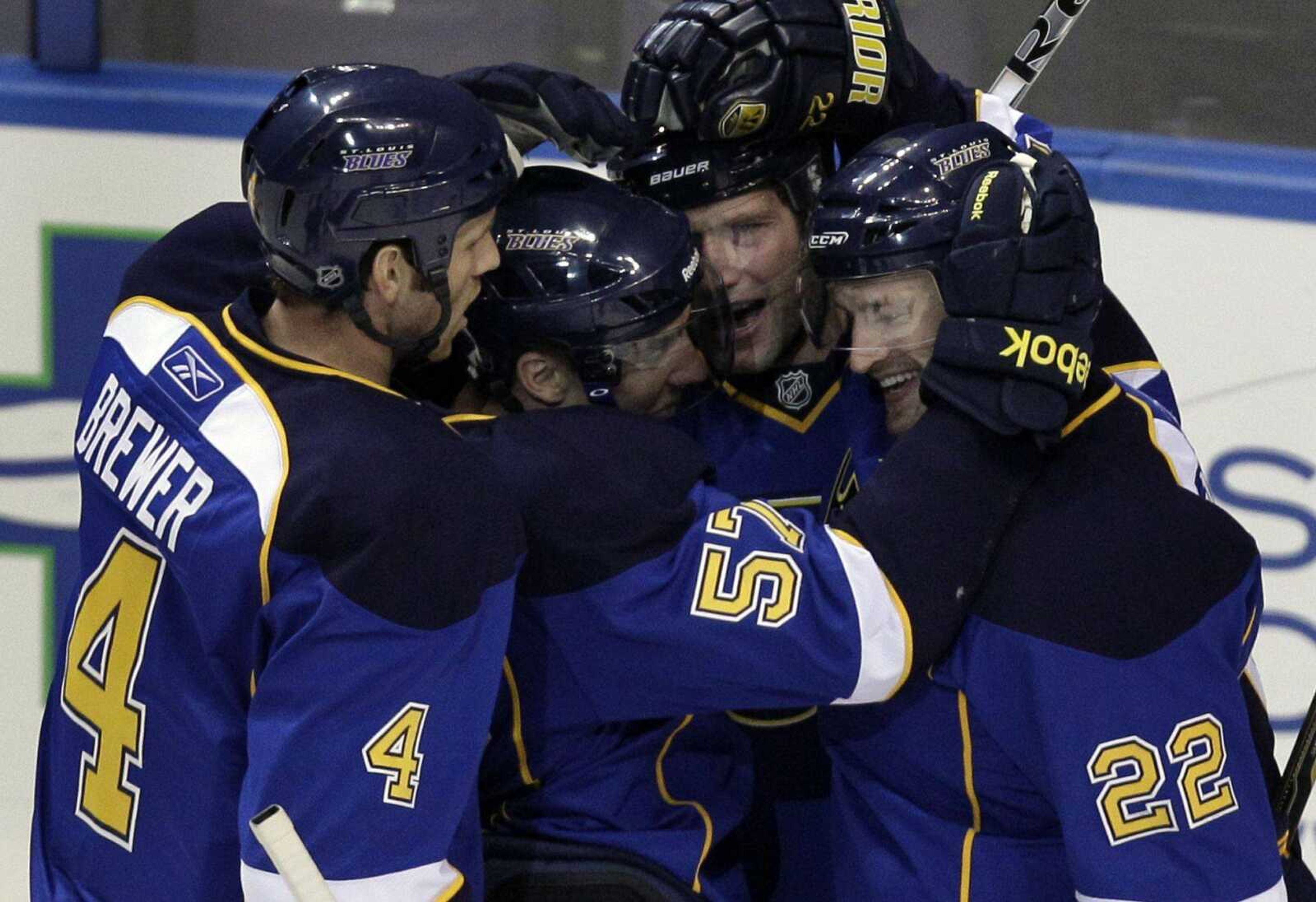 The Blues' David Backes, second from right, is congratulated by teammates Eric Brewer (4), David Perron (57) and Brad Boyes (22) after scoring during the first period Monday against the Ducks in St. Louis. (Jeff Roberson ~ Associated Press)