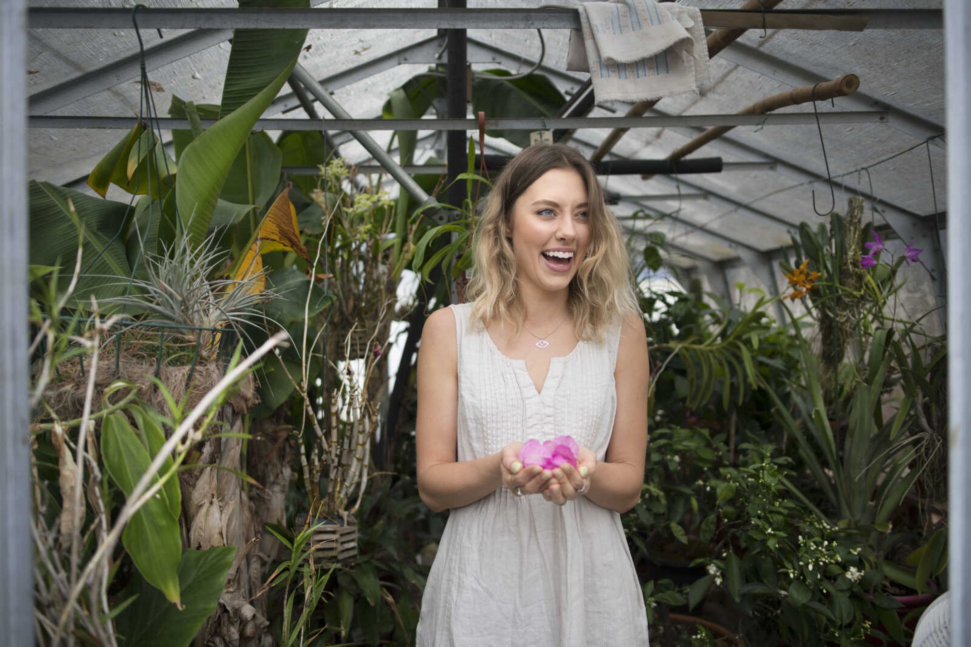 Monica Foultz poses for a photo on Friday, Jan. 24, 2020, at Jim Hoffman's home greenhouse in Cape Girardeau.