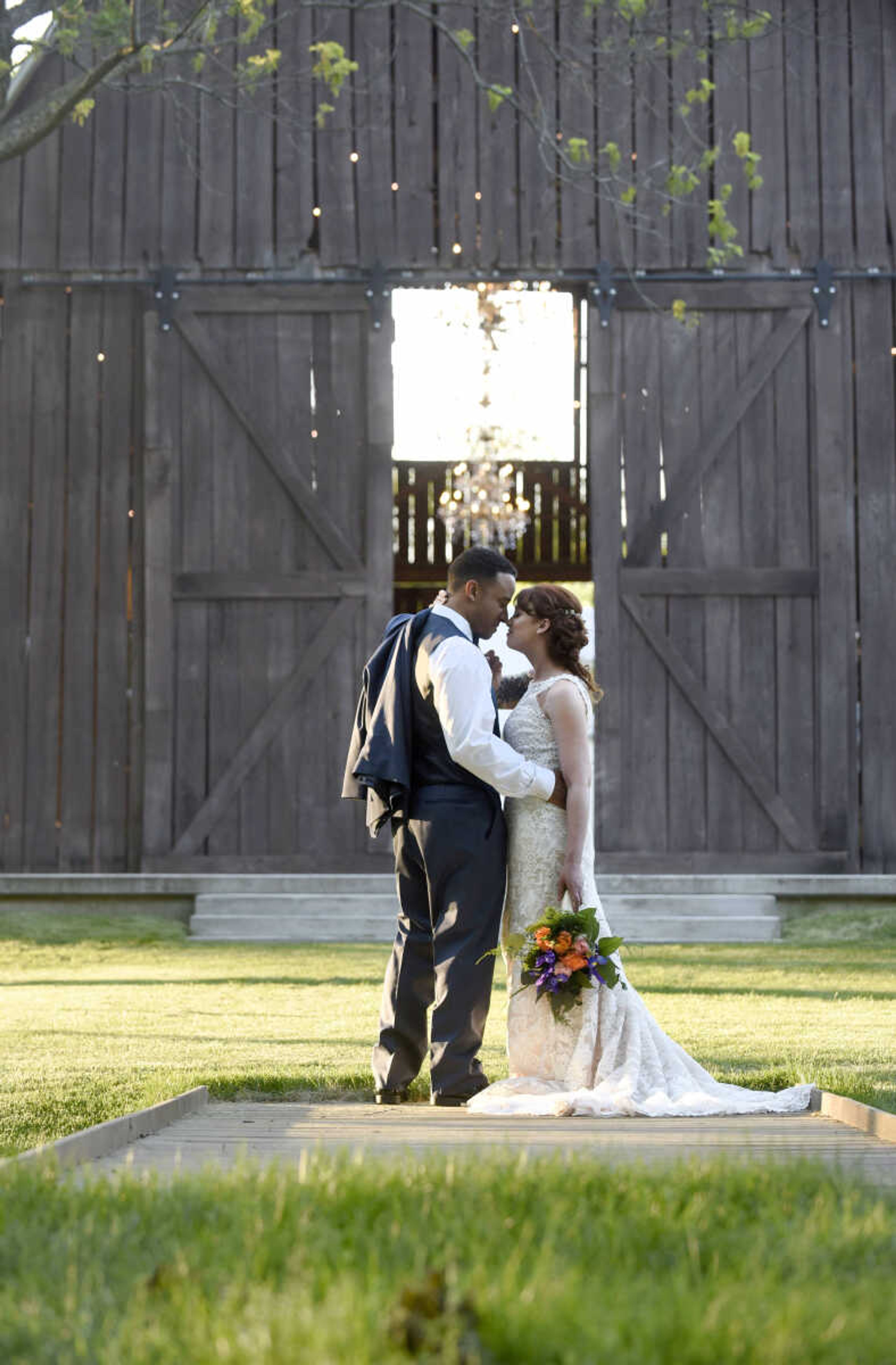 This Eddy K dress is a fit and flare, ivory on champagne colored gown. It has heavily embroidered symmetrical lace over velure tulle, with a detailed illusion back. Available at Ann-Louise Bridal in Jackson. 

Wedding suits courtesy of Jim's Formal Wear and available at Garber's Men's Wear in Cape Girardeau.