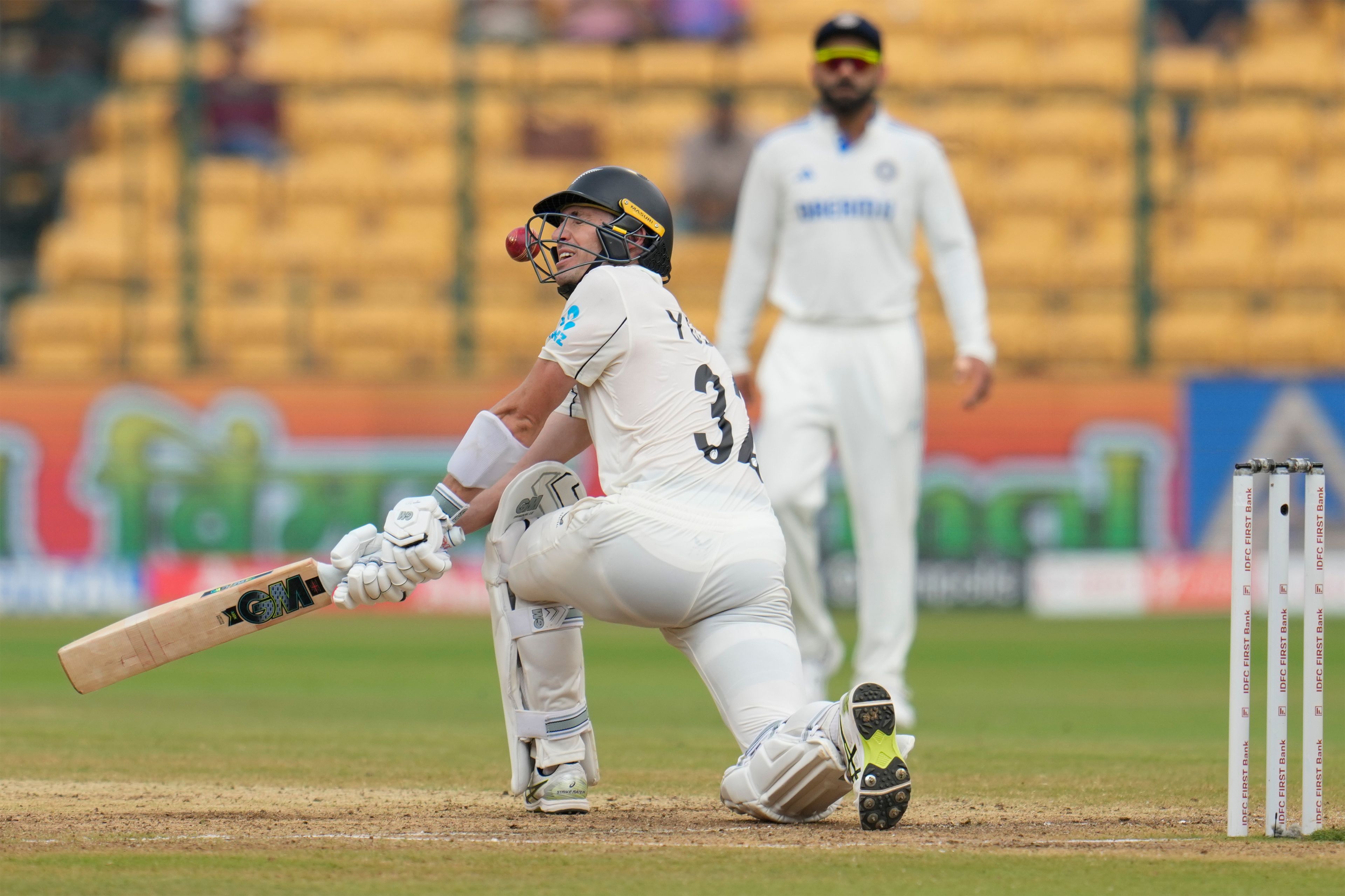 The ball hits the helmet of New Zealand's Will Young as he attempts to play a shot on a delivery by India's Ravindra Jadeja during the day five of the first cricket test match between India and New Zealand at the M.Chinnaswamy Stadium, in Bengaluru, India, Sunday, Oct. 20, 2024. (AP Photo/Aijaz Rahi)