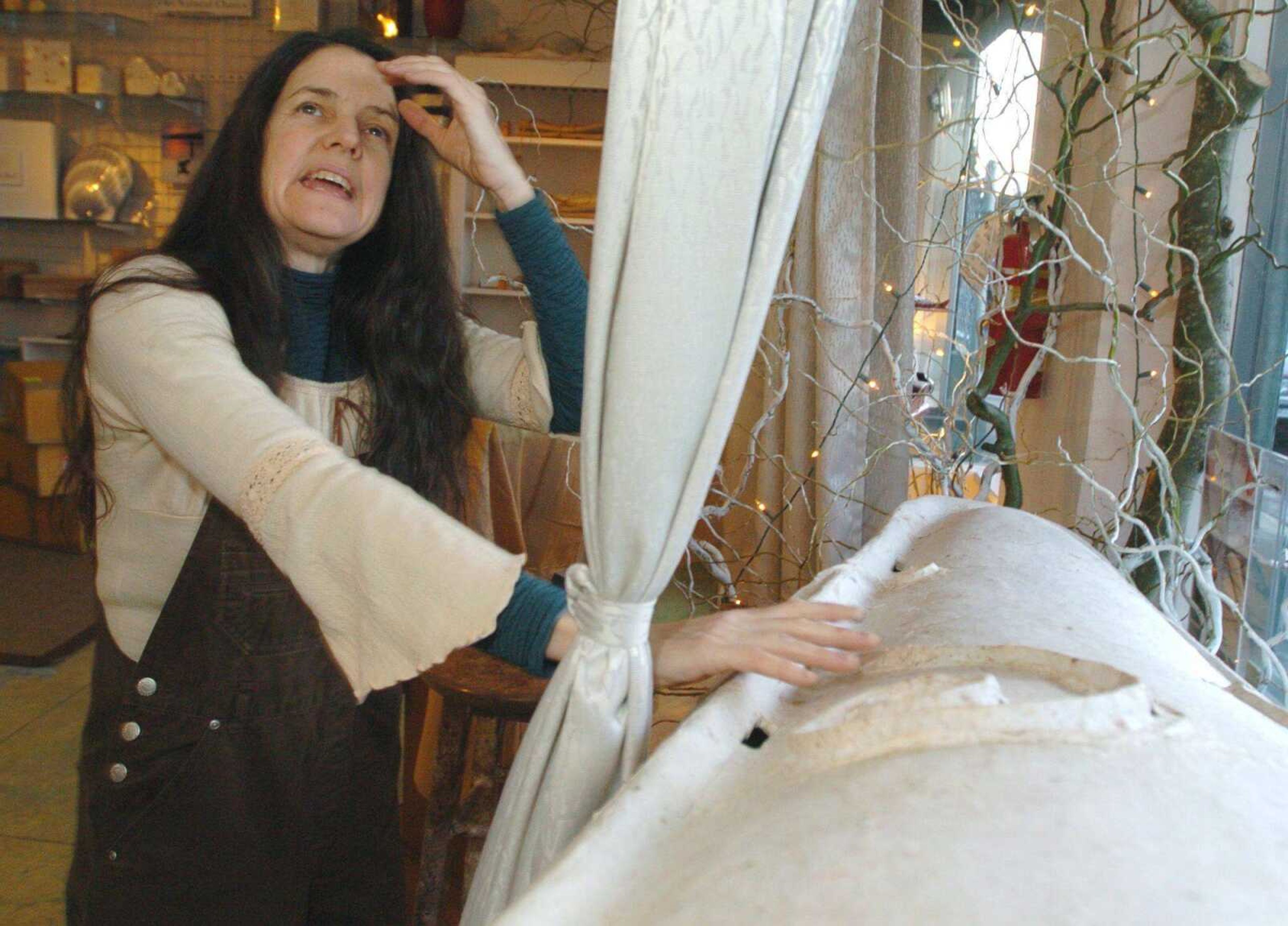 Cynthia Beal talks about the Ecopod, a kayak-looking container made out of recycled newspaper from the United Kingdom, at her store, The Natural Burial Company, in Portland, Ore., Thursday, December 20, 2007.  Beal's store will be the first in the United States to sell the Ecopod.  (AP Photo/Greg Wahl-Stephens)