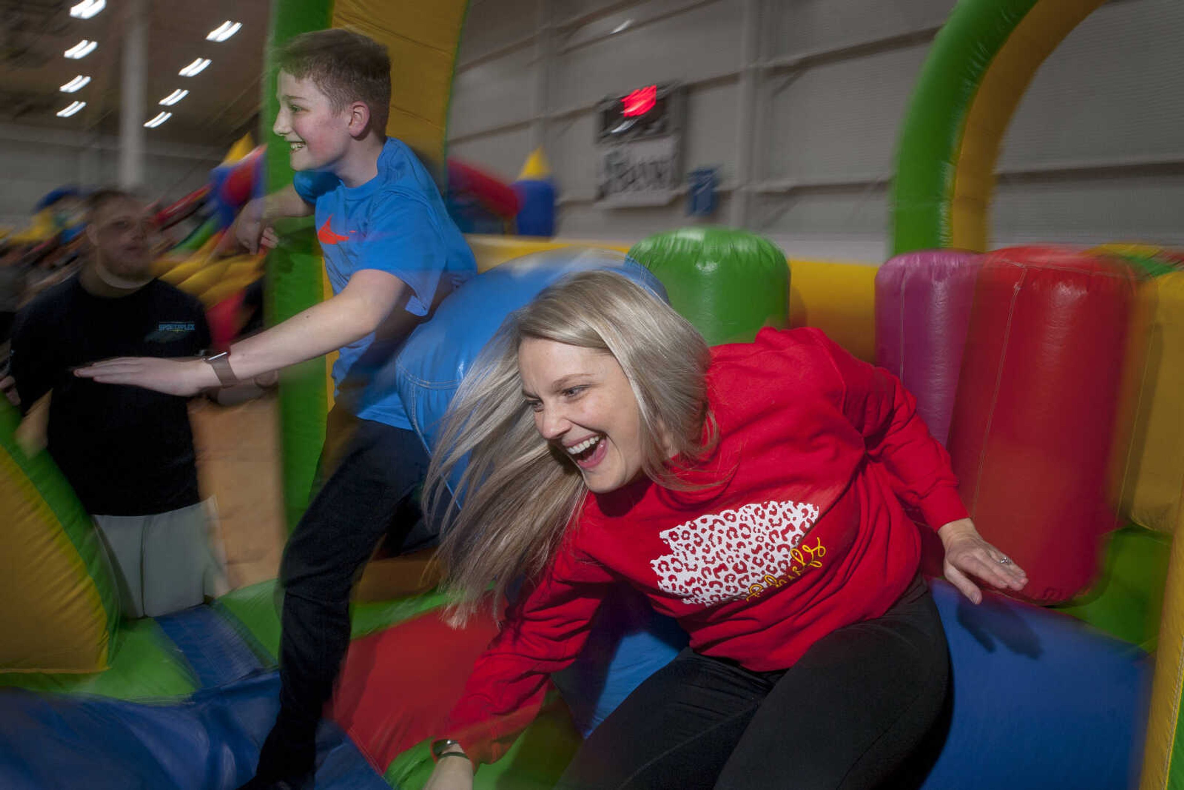 Amy Camp and her son Mason Oliver run through an inflatable obstacle course during a mother/son game night Saturday, Feb. 22, 2020, at the Sports Plex in Cape Girardeau.