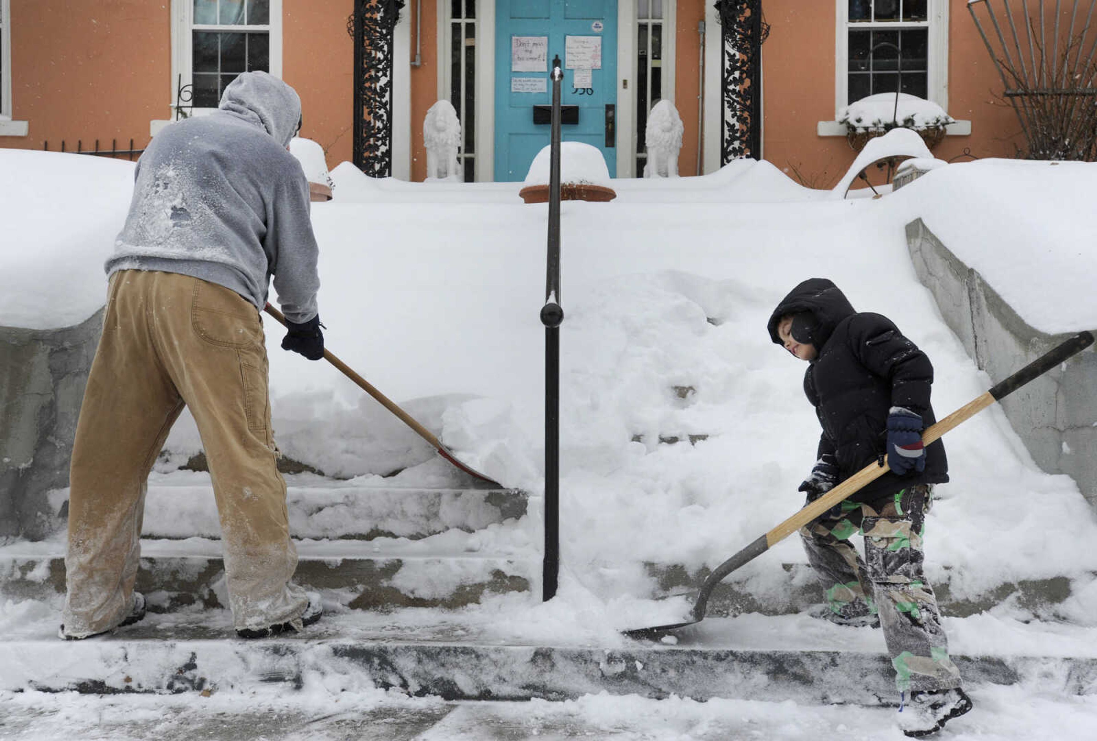 LAURA SIMON ~ lsimon@semissourian.com

Rocky Everett and his son Fletcher, clear snow from the steps outside Annie Laurie's Antiques, Monday, Feb. 16, 2015, in Cape Girardeau.