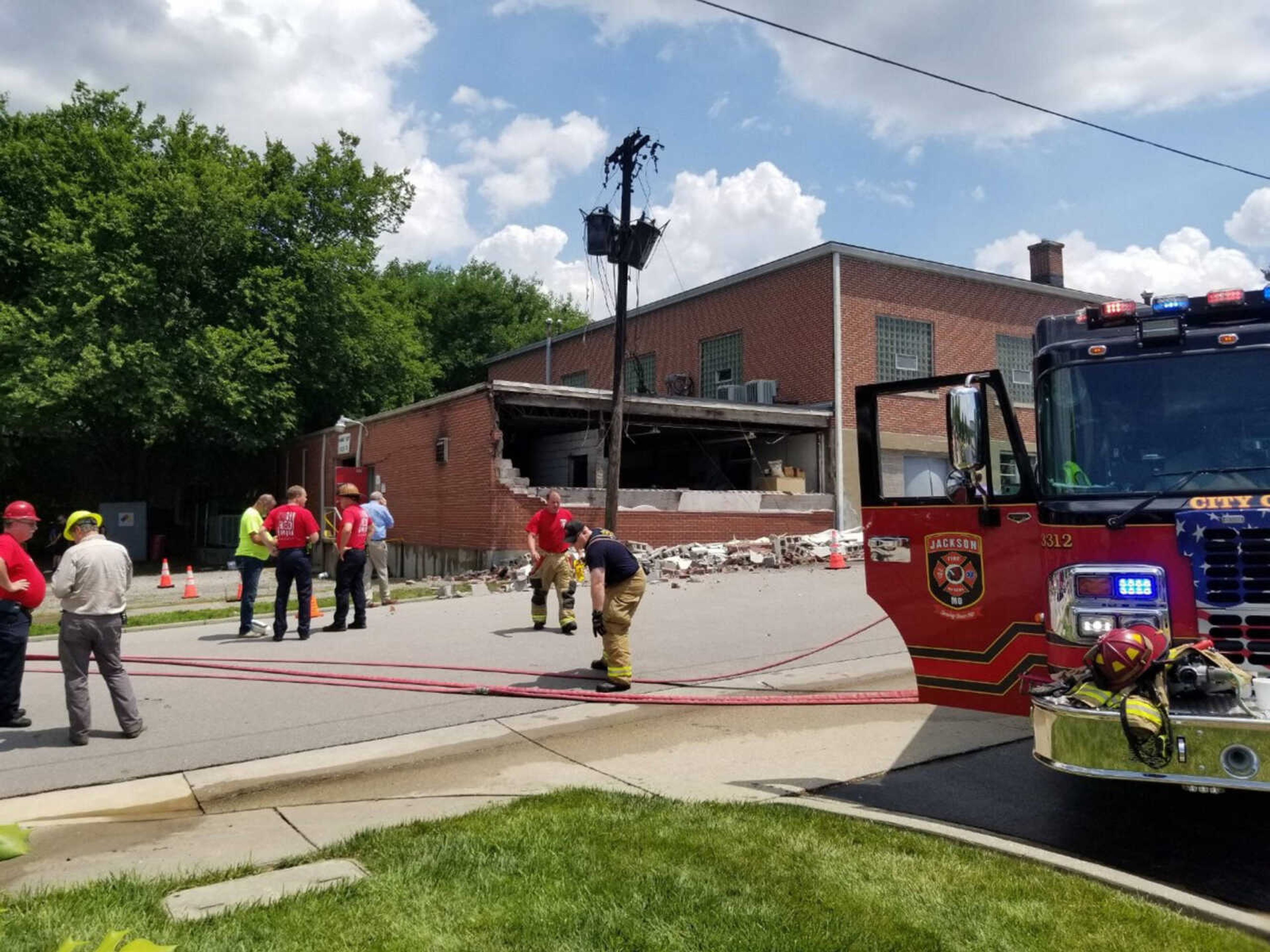 Jackson Fire Rescue cleans up and inspects the scene after containing the fire at the Lenco building on Friday in Jackson.