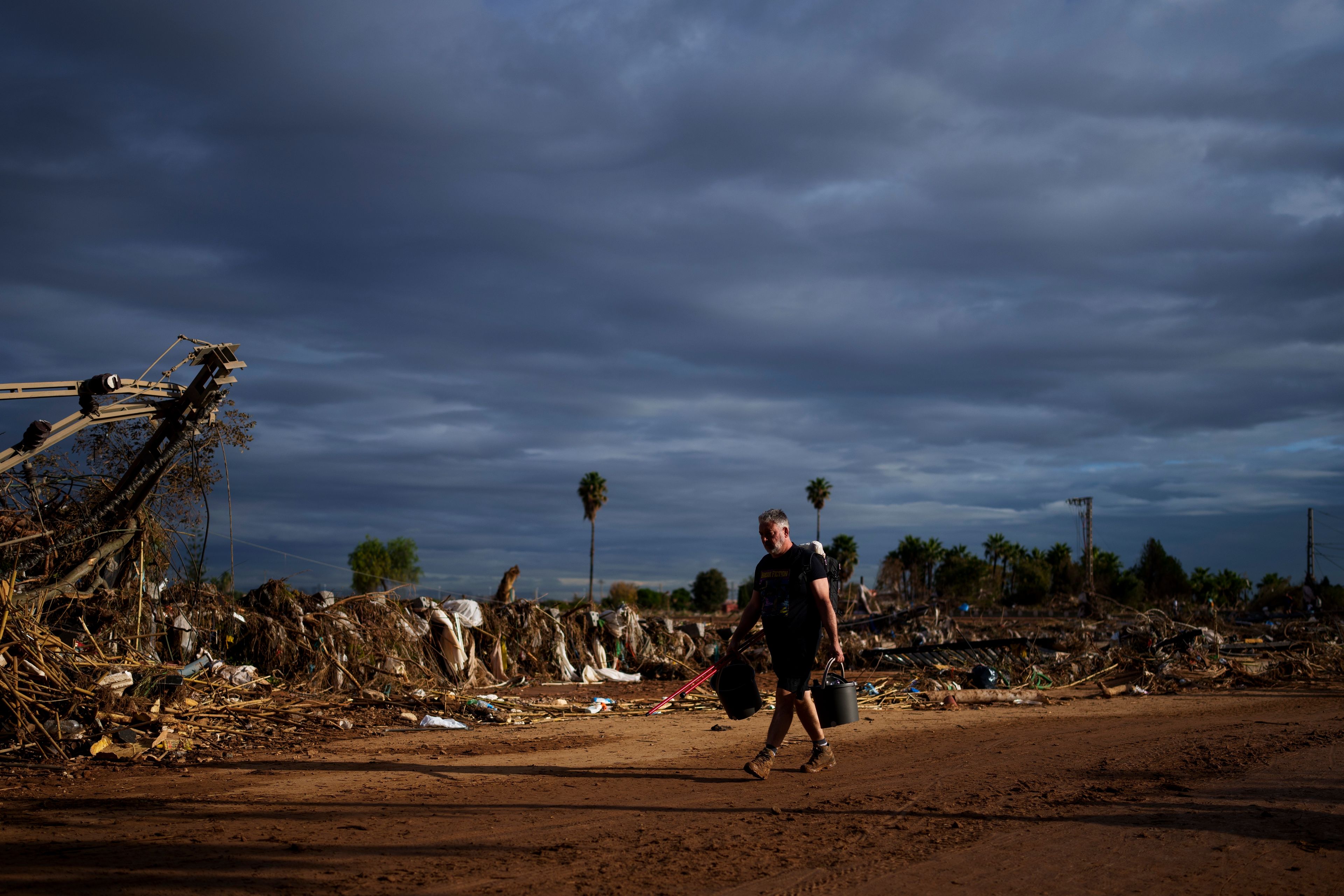 A man walks through a street affected by floods in Paiporta, the epicenter of the storm, near Valencia, Spain, Saturday, Nov. 2, 2024. (AP Photo/Manu Fernandez)