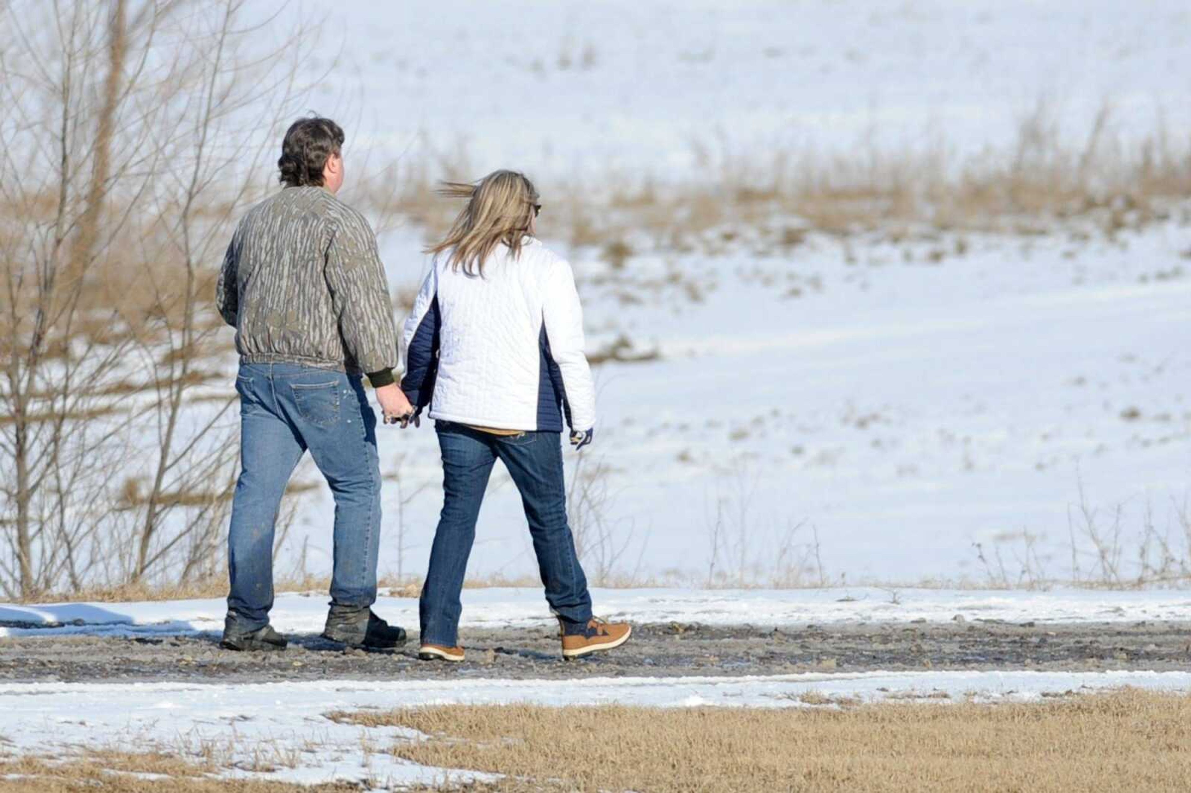 Jimmy and Marsha Johnston walk to the staging area during the search Wednesday afternoon for their missing son, Zack.