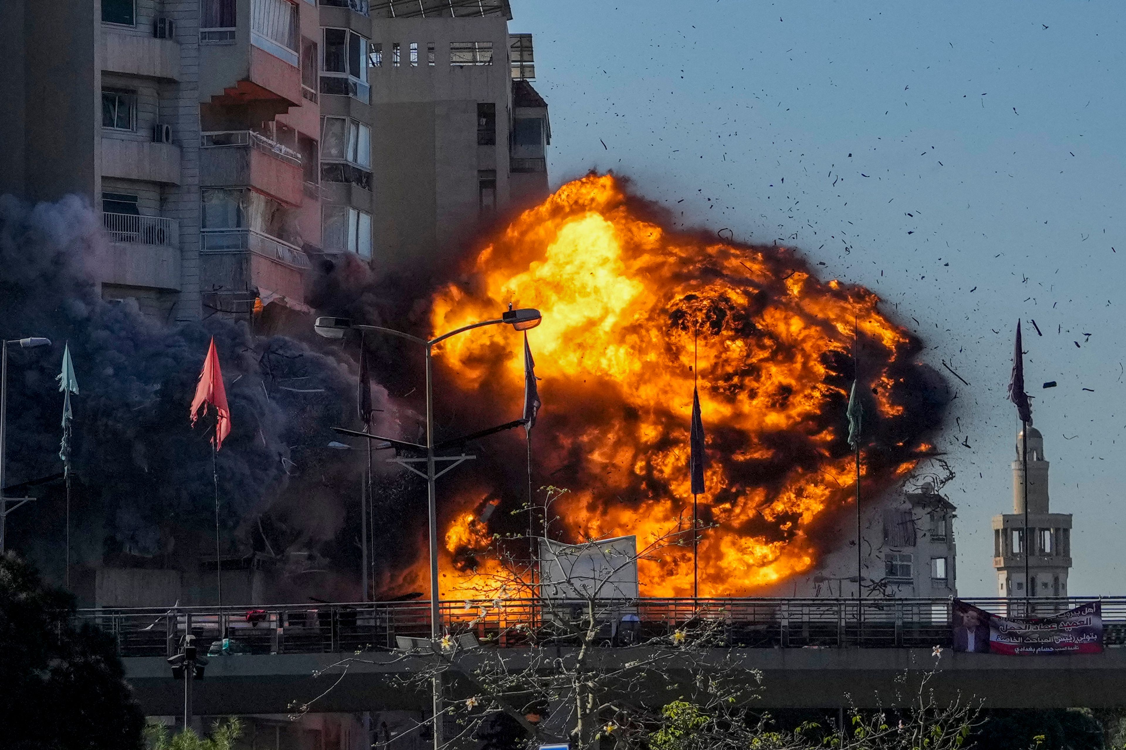 Thick smoke and flames erupt from an Israeli airstrike on Tayouneh, Beirut, Lebanon, Friday, Nov. 15, 2024. (AP Photo/Hassan Ammar)