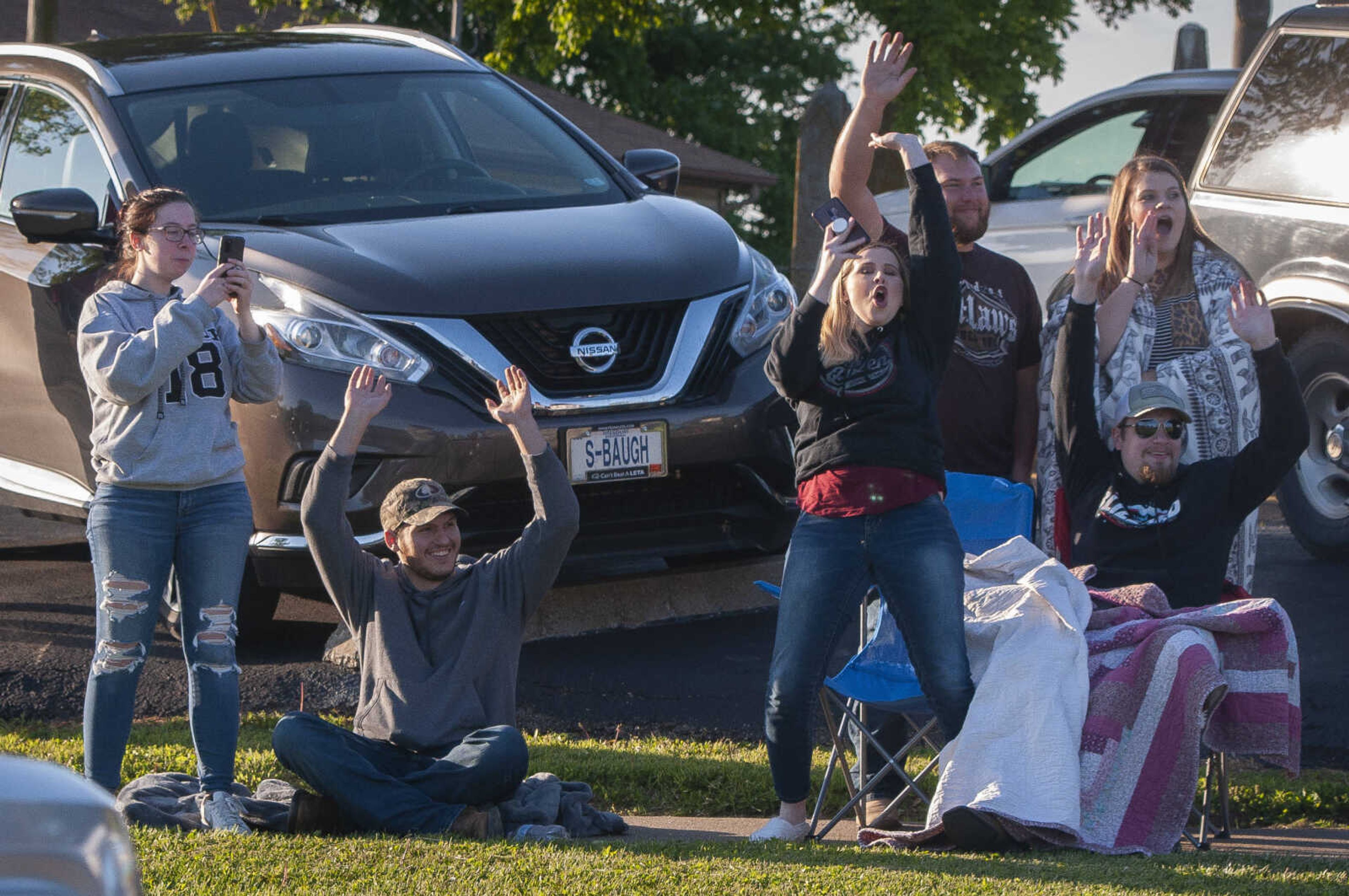 Parade watchers cheer during a parade for Oak Ridge High School seniors Friday, May 8, 2020, in Oak Ridge.