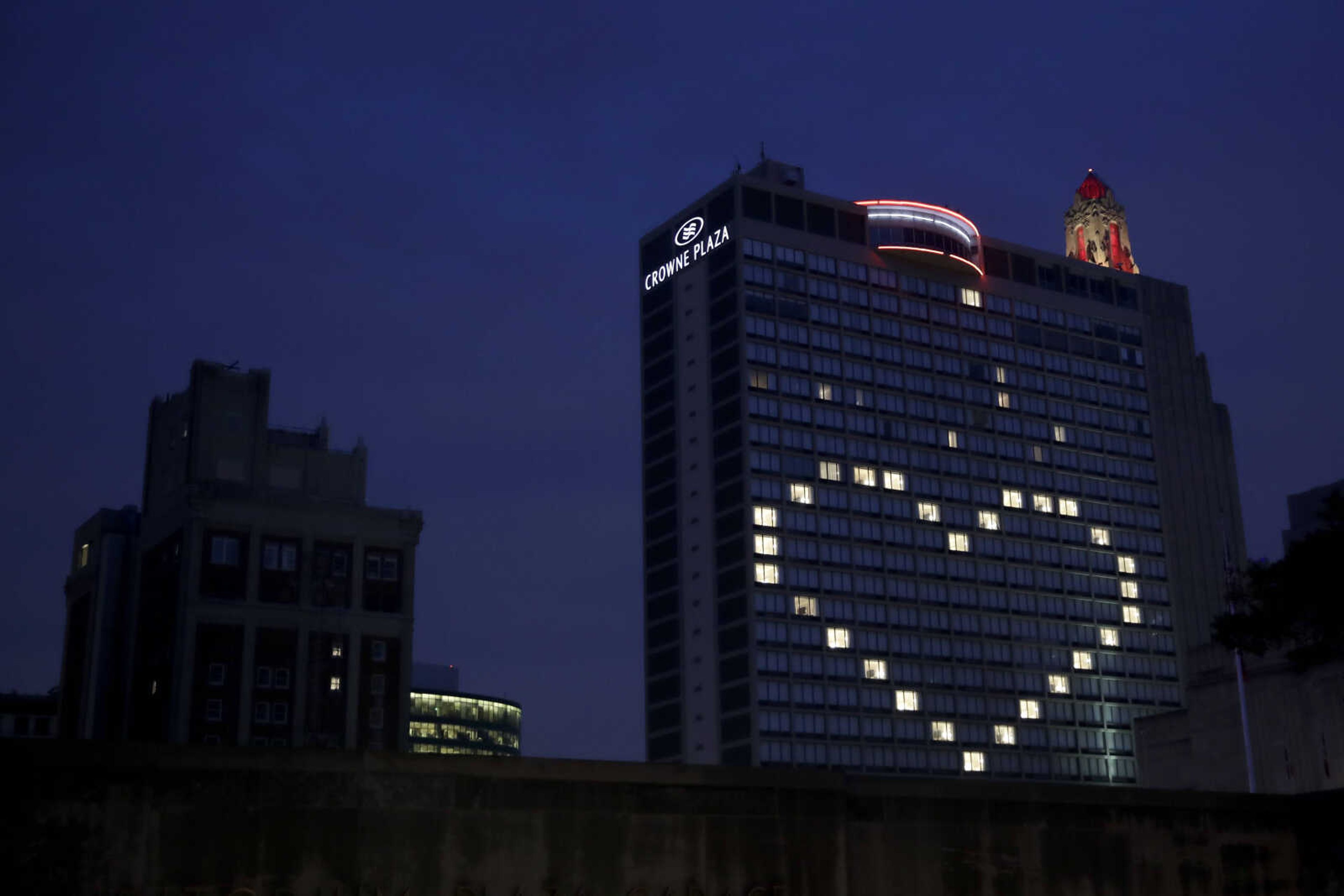 A downtown hotel leaves lights on in vacant room windows to form a heart Friday, March 27, 2020, in Kansas City, Mo. Hotels and other travel sector businesses are feeling the brunt of the economic downturn as much of the country stays home to help stem the spread of the new coronavirus. 