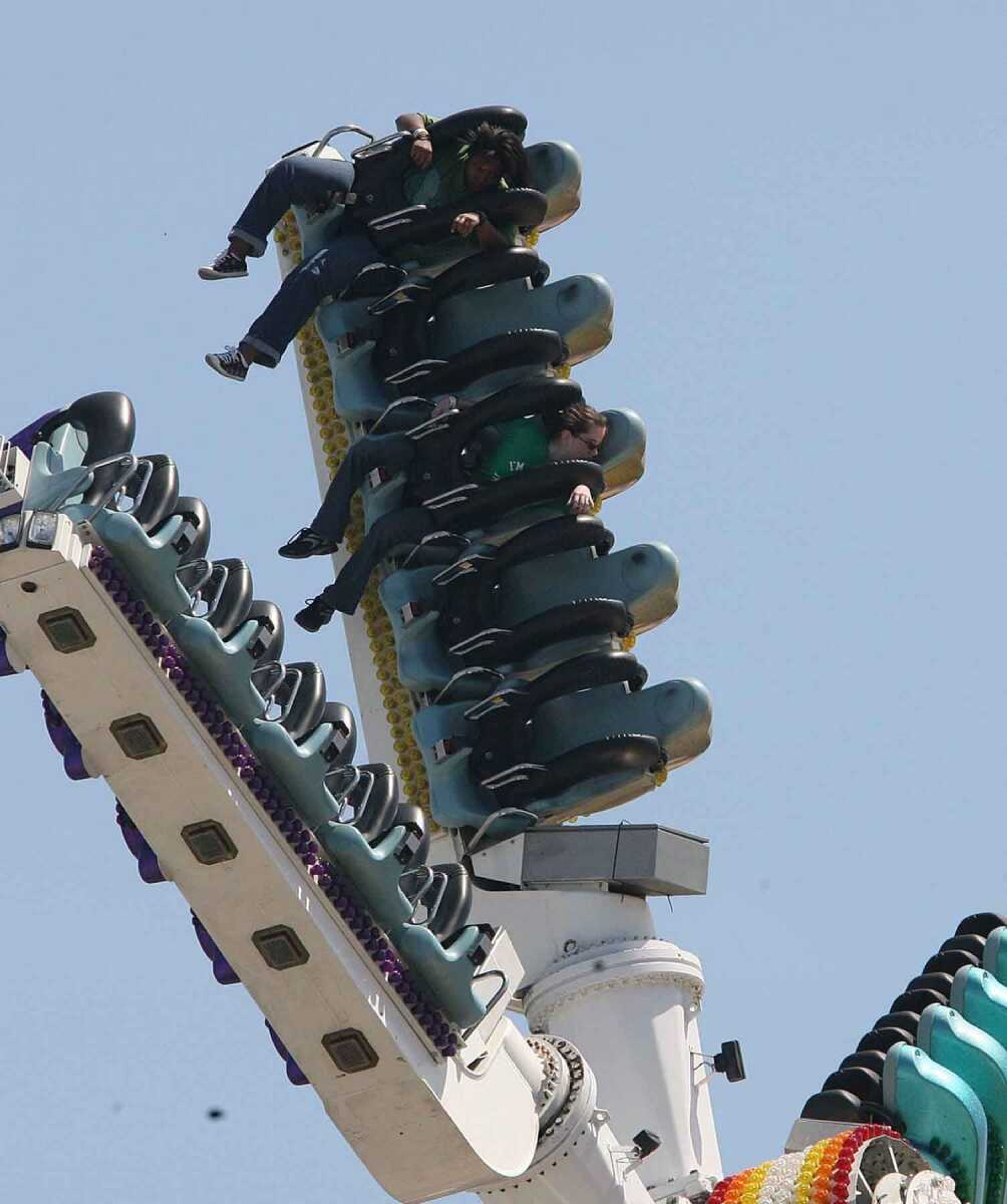 Two young adults are trapped at the "Skyroller" ride at the Miami Youth Fair after the ride got stuck Tuesday, March 30, 2010. Miami Fire Rescue and Fair personnel rescued thetwo people after nearly an hour with a cherry picker. (AP Photo/El Nuevo Herald, Hector Gabino)