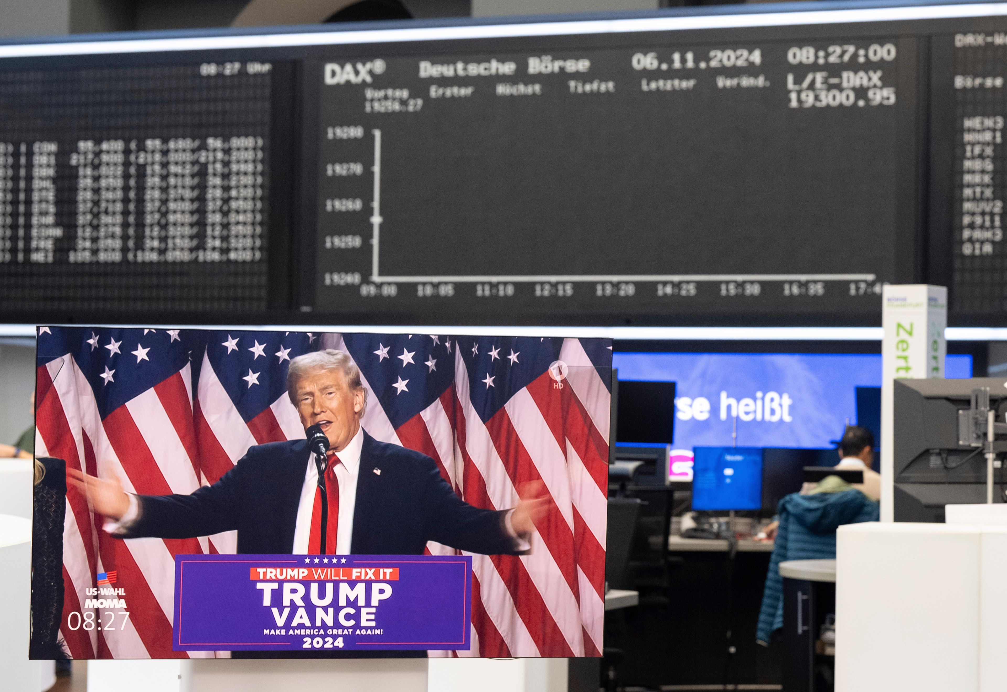 A speech by Republican presidential nominee former President Donald Trump is broadcast live on a monitor in the trading hall of Deutsche Börse in Frankfurt, Germany, Wednesday, Nov. 6, 2024. (Boris Roessler/dpa via AP)