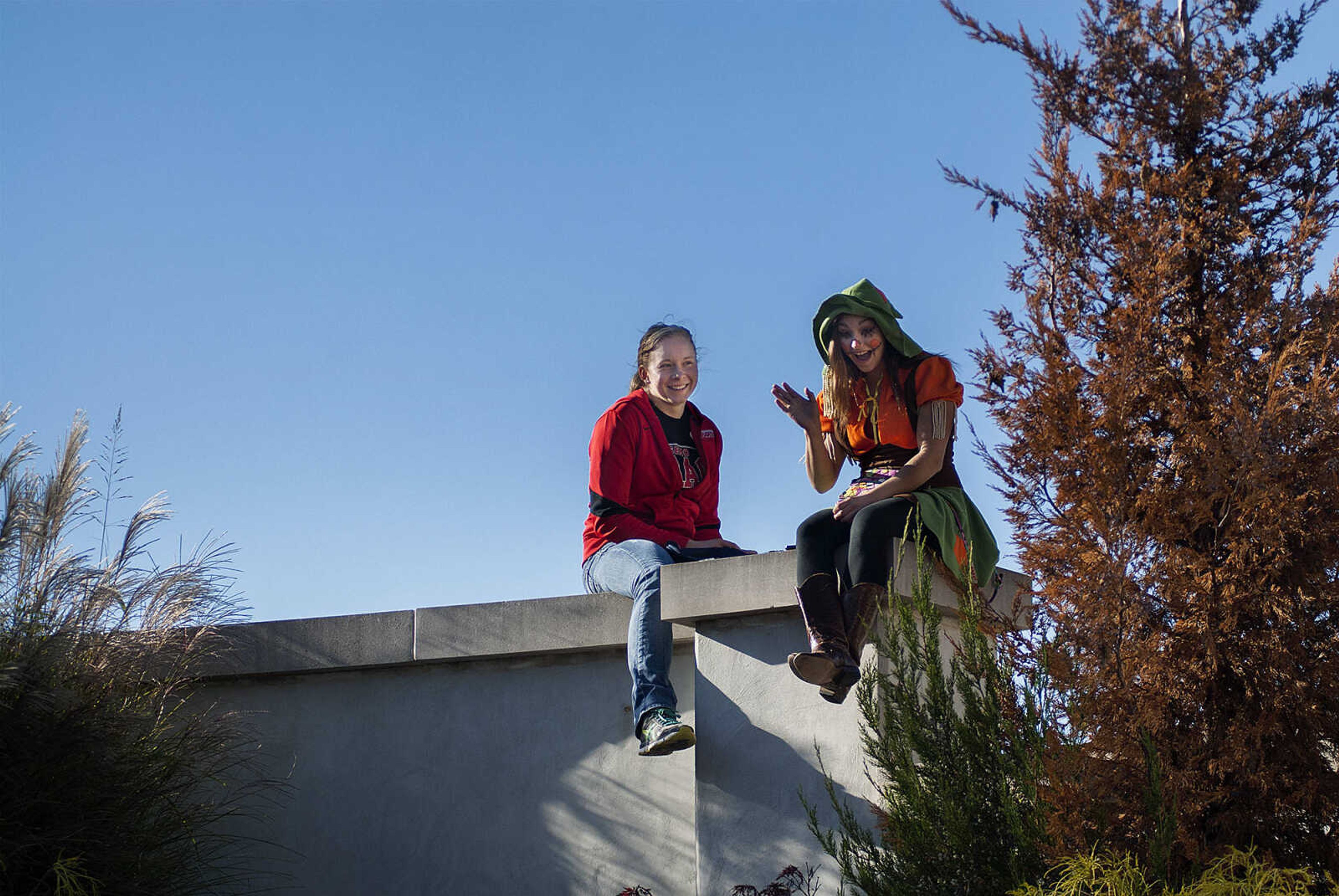 Southeast Missouri state University students Taylor Penzien, left, and Haley Holton wave to a child dressed as a firefighter during the fifth annual Halloween Science Night Sunday, Oct. 20, on the campus of Southeast Missouri State University. The event featured 21 stations, such as the "Scream Room," "Creepy Creatures," or the "Mucus Lab," each with a different Halloween themed science activity. The night is funded by a grant from the Missouri Foundation for Health in partnership with Southeast's College of Science, Technology and Agriculture and Extended and Continuing Education.