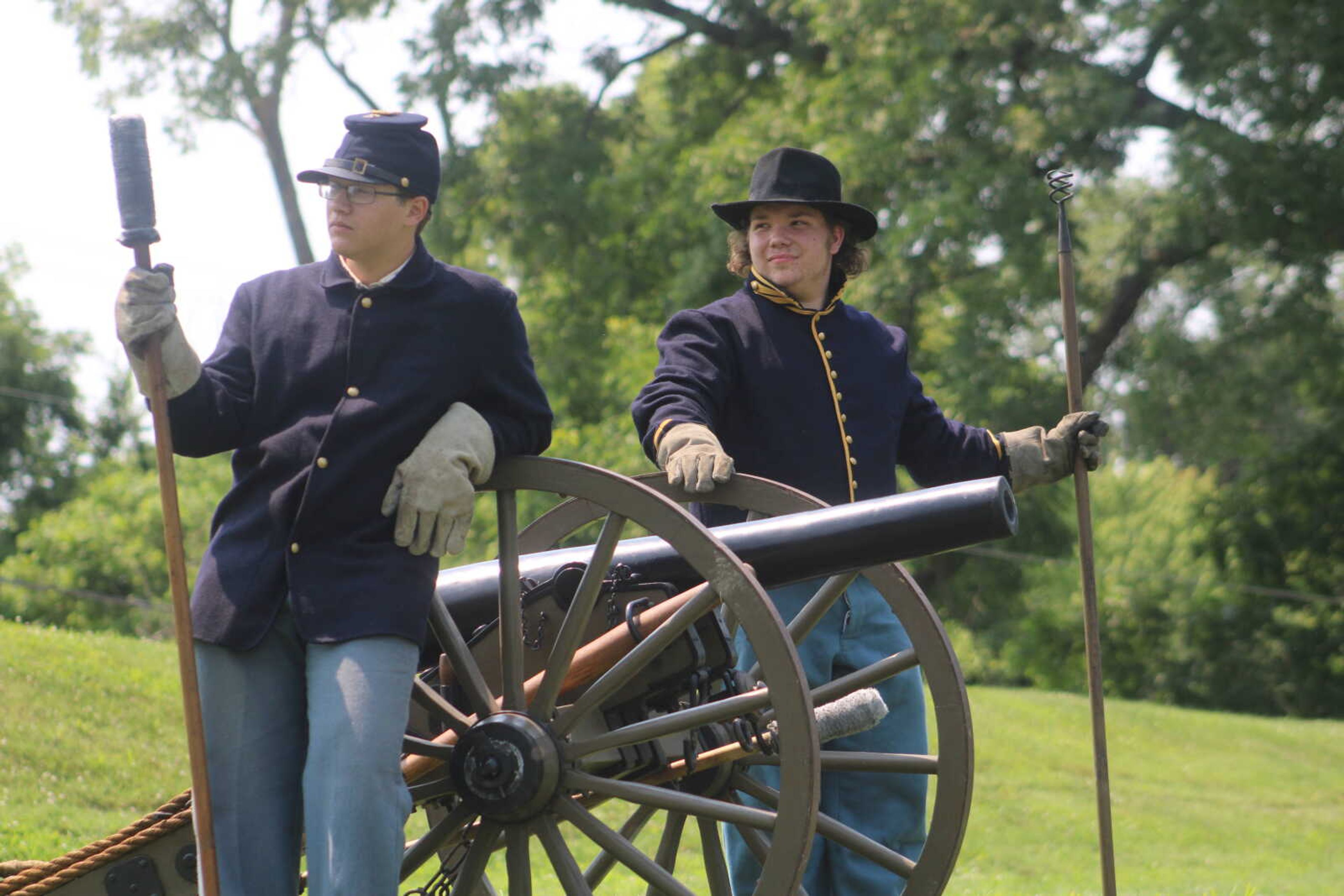 Andrew Porter, 15, left, and Dalton Blankenship, 15, lean against the replica cannon at Fort D Historic Site in Cape Girardeau on Sunday, July 4, 2021.