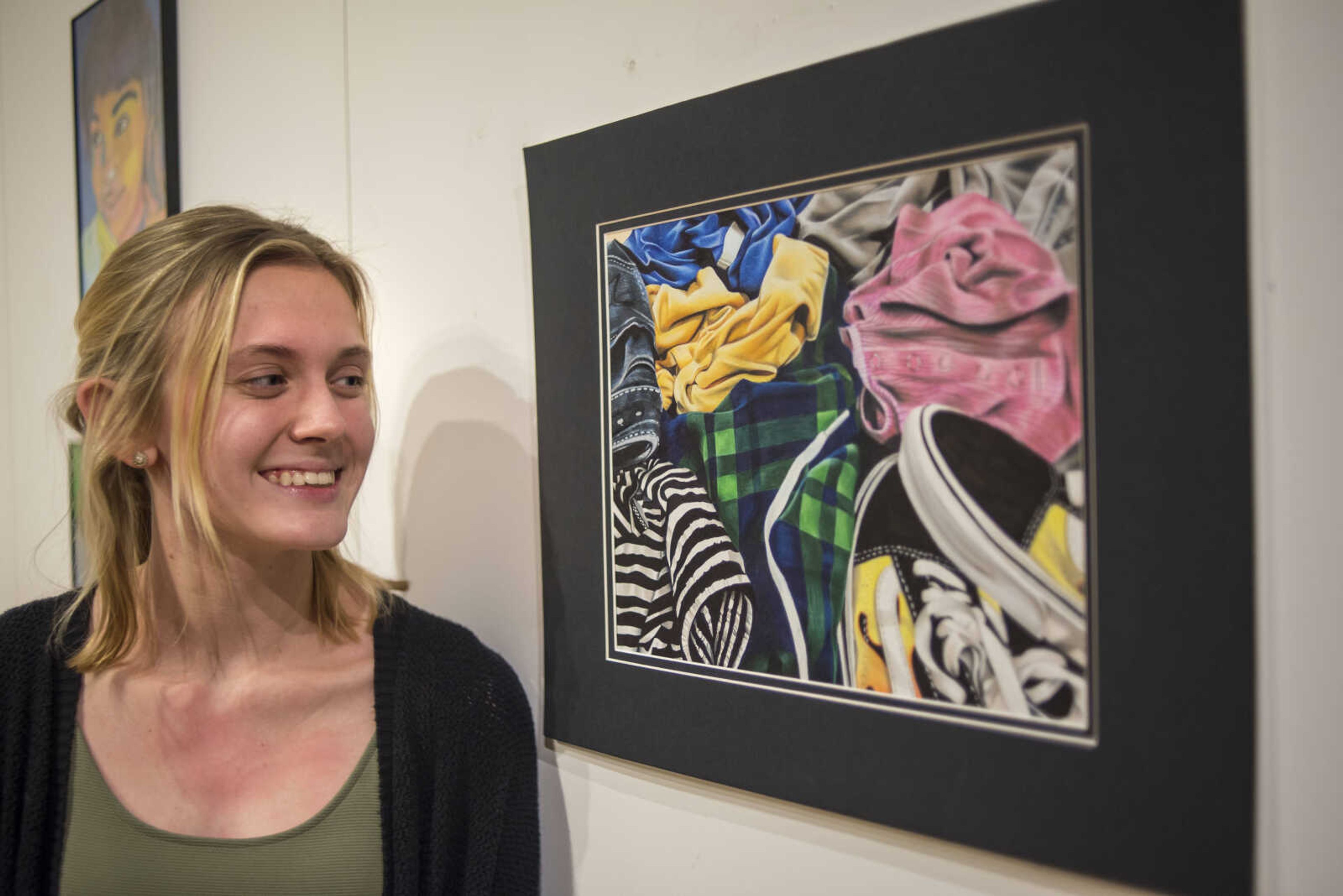 Poplar Bluff student Megan Murphy poses with her drawing, "I need to do Laundry," which won Best in Show during the 41st annual Exhibiting Excellence high school art exhibit at the Crisp Museum at Southeast Missouri State University's River Campus Sunday, Feb. 10, 2019.