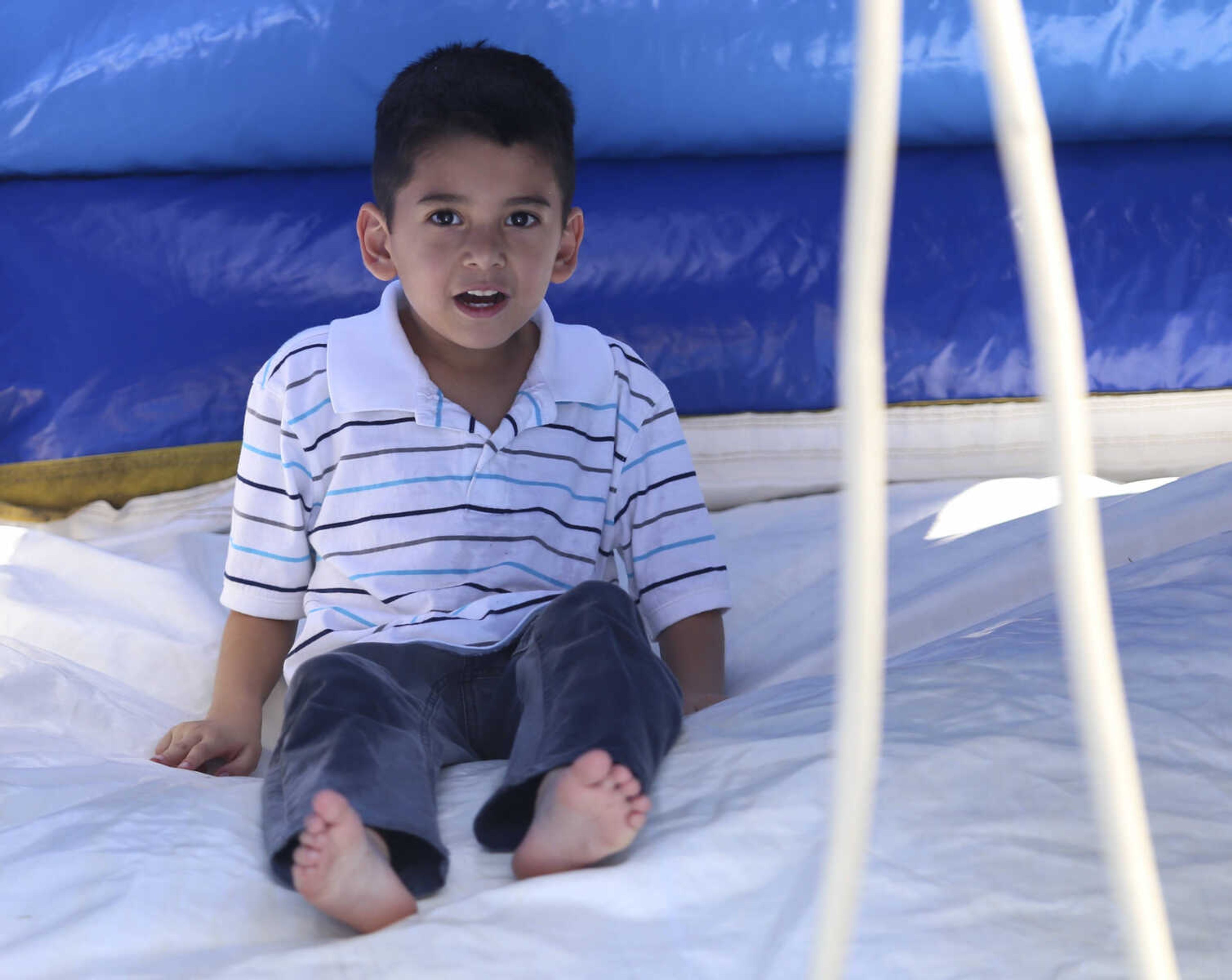 Avian Garcia plays on a bounce house at the St. Mary Cathedral parish picnic on Sunday, August 27, 2017, in Cape Girardeau.