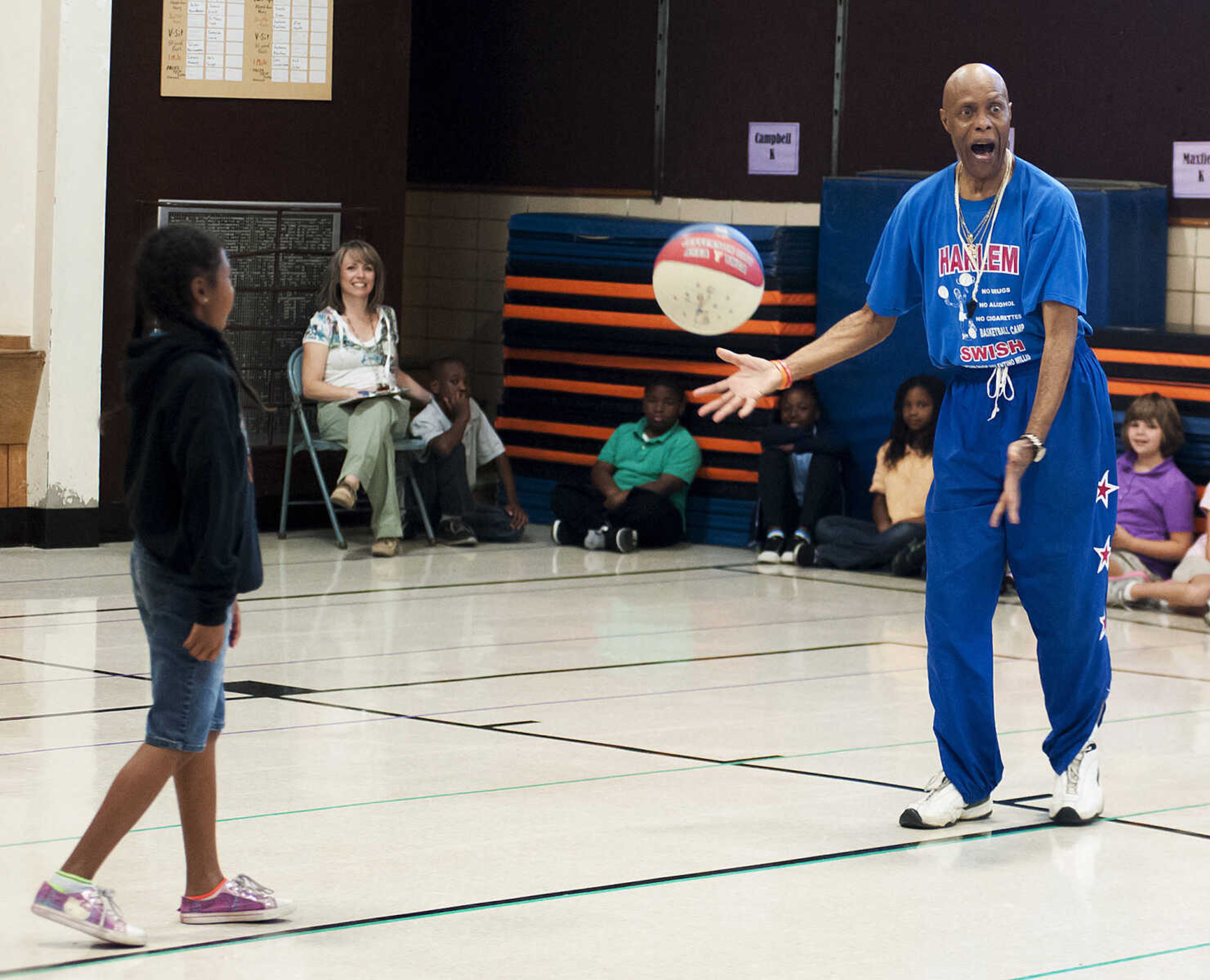 Captain "Magic" Valentino Willis gets some help from Briaysia Purl during his presentation at Jefferson Elementary School Tuesday, Sept. 24, in Cape Girardeau. Willis, who is with the Harlem Swish Comedic Basketball Team, used his basketball and comedy skills to encourage the students to not smoke, drink or do drugs while respecting their teachers, principals, coaches and each other.