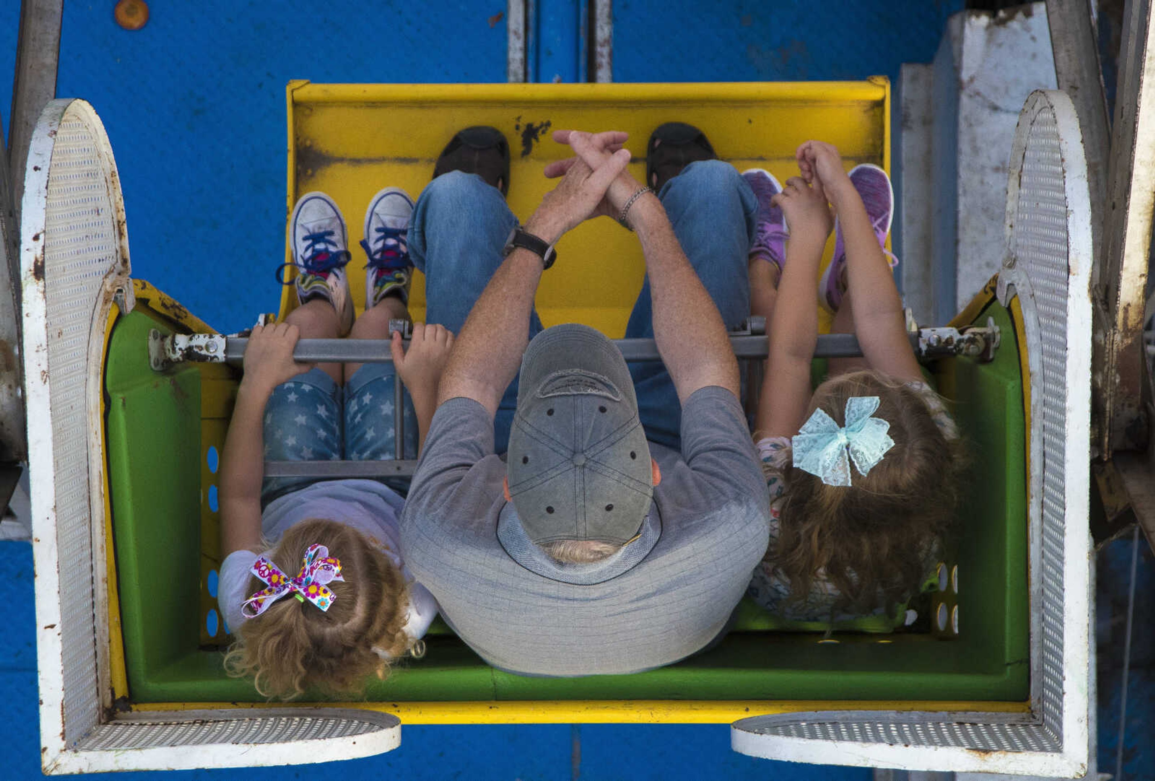 Gabrielle Bachkora, Richard Hartman and Aubrey Bachkora, 5, ride the ferris wheel at the Jackson Homecomers Tuesday, July 25, 2017 in Uptown Jackson.