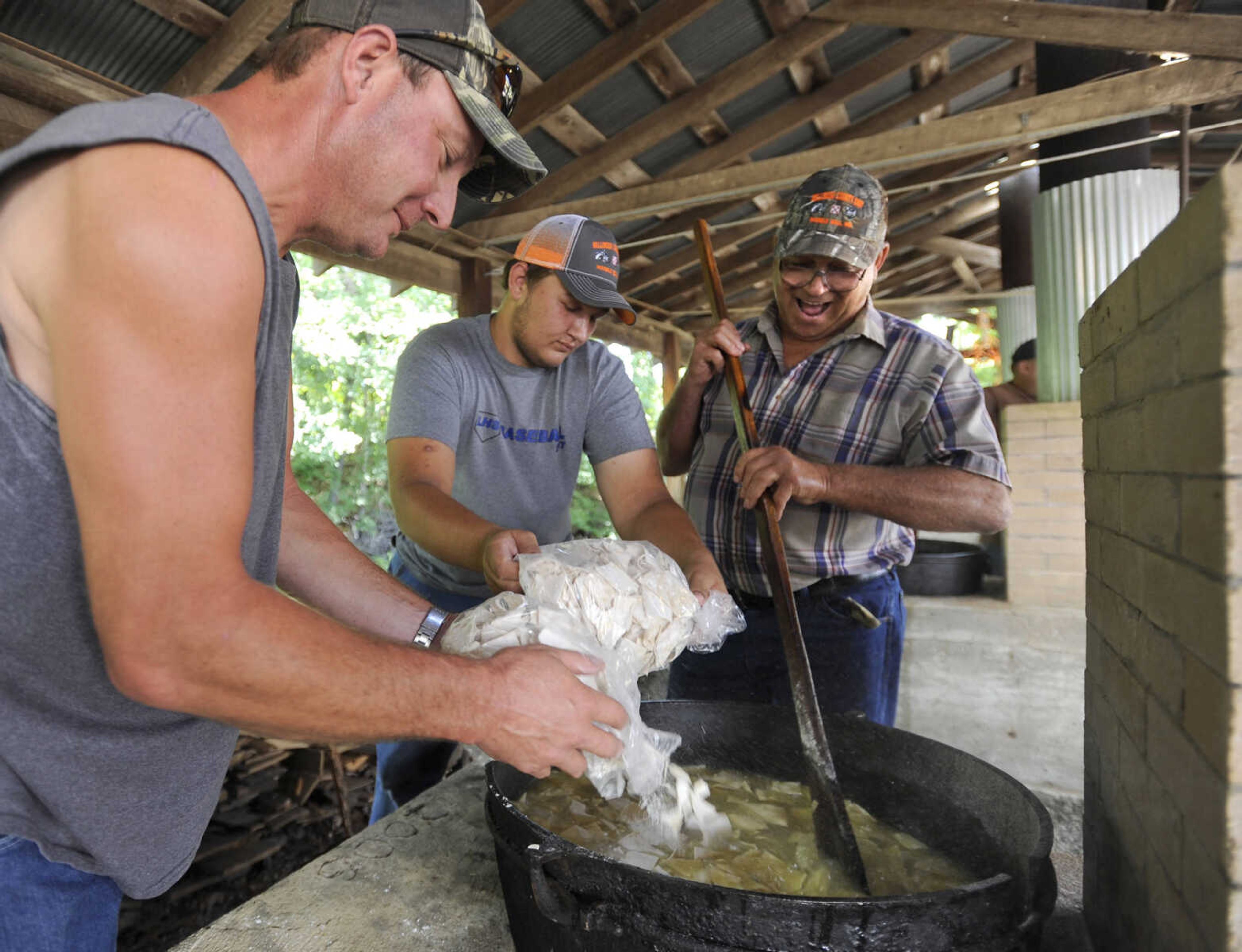 FRED LYNCH ~ flynch@semissourian.com
Andrew Jansen, left, and Blake Leazenby add frozen dumplings to the kettle stirred by Glen Seiler on Saturday, July 29, 2017 at the St. John's Church Picnic in Leopold, Missouri.