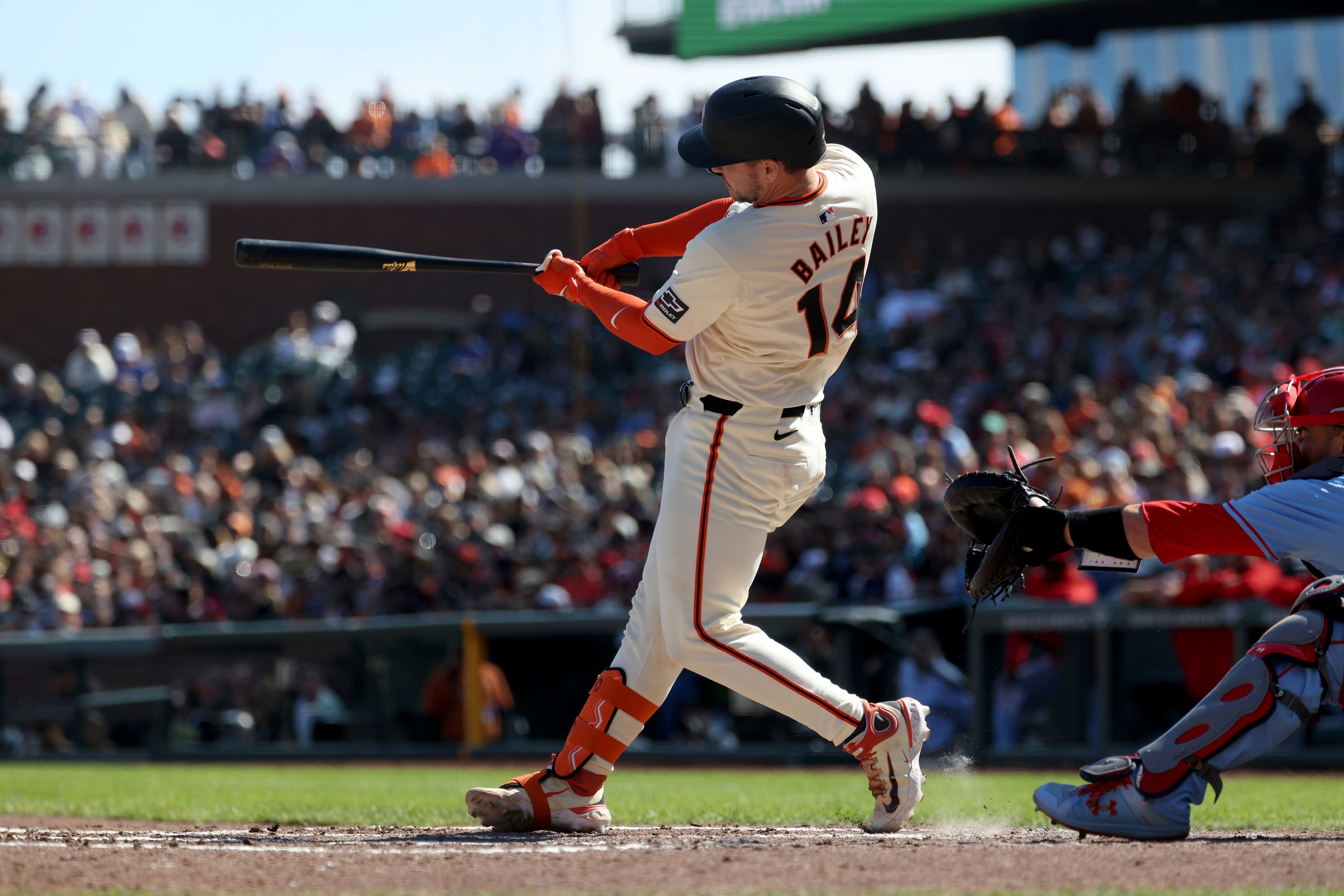 San Francisco Giants' Patrick Bailey hits an RBI single in front of St. Louis Cardinals catcher Pedro Pagés, right, during the fourth inning of a baseball game in San Francisco, Saturday, Sept. 28, 2024. (AP Photo/Jed Jacobsohn)