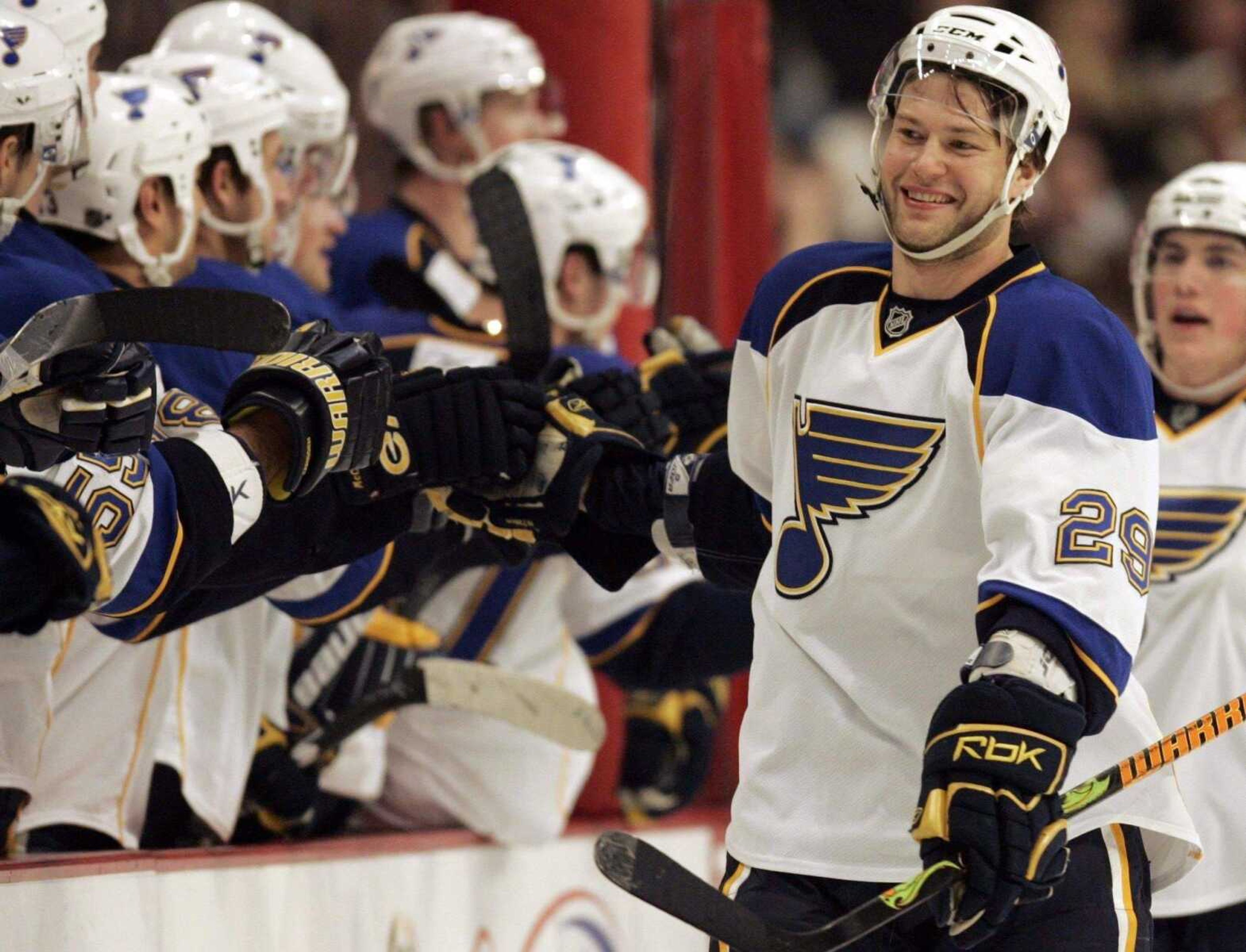 Nam Y. Huh ~ Associated Press<br>The Blues' Jeff Woywitka celebrates with his teammates after scoring his first goal of the season during the first period Wednesday against the Blackhawks in Chicago.