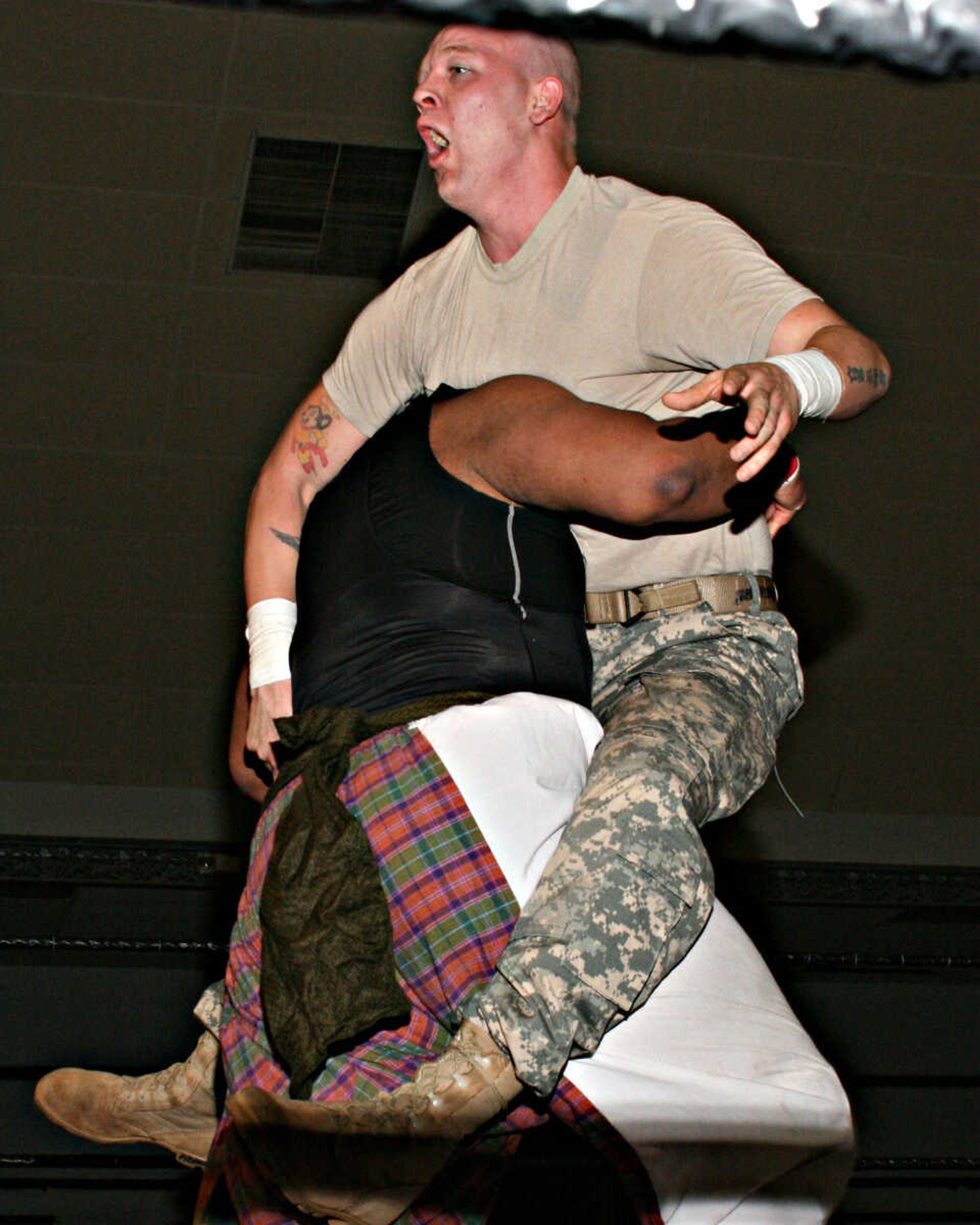 Professional wrestler Jason "The Fury" Vaughn takes on Bilal Nauden during a March 28 fund-raiser for the Boys & Girls Club of Cape Girardeau. The event was sponsored by the Missouri National Guard. Vaughn is also a Guard soldier with the 1221 Transportation Co. in Dexter, Mo. (Photo courtesy of Pat Slayton.)