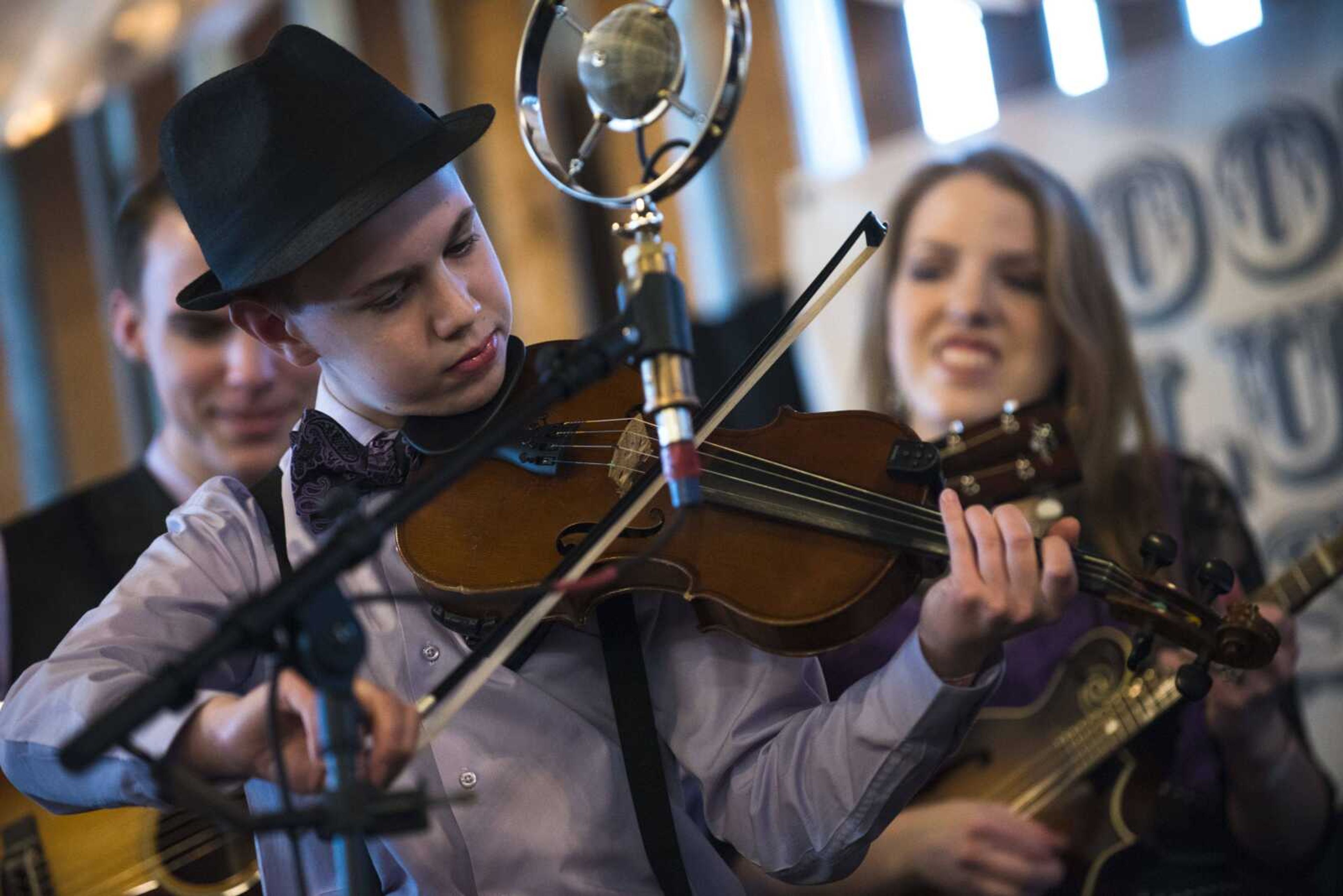 John-Mark Sowell, 13, plays "Thank God for the Dollar Store" with The Family Sowell at the Bootheel Bluegrass Festival on Friday at Bavarian Halle in Fruitland.