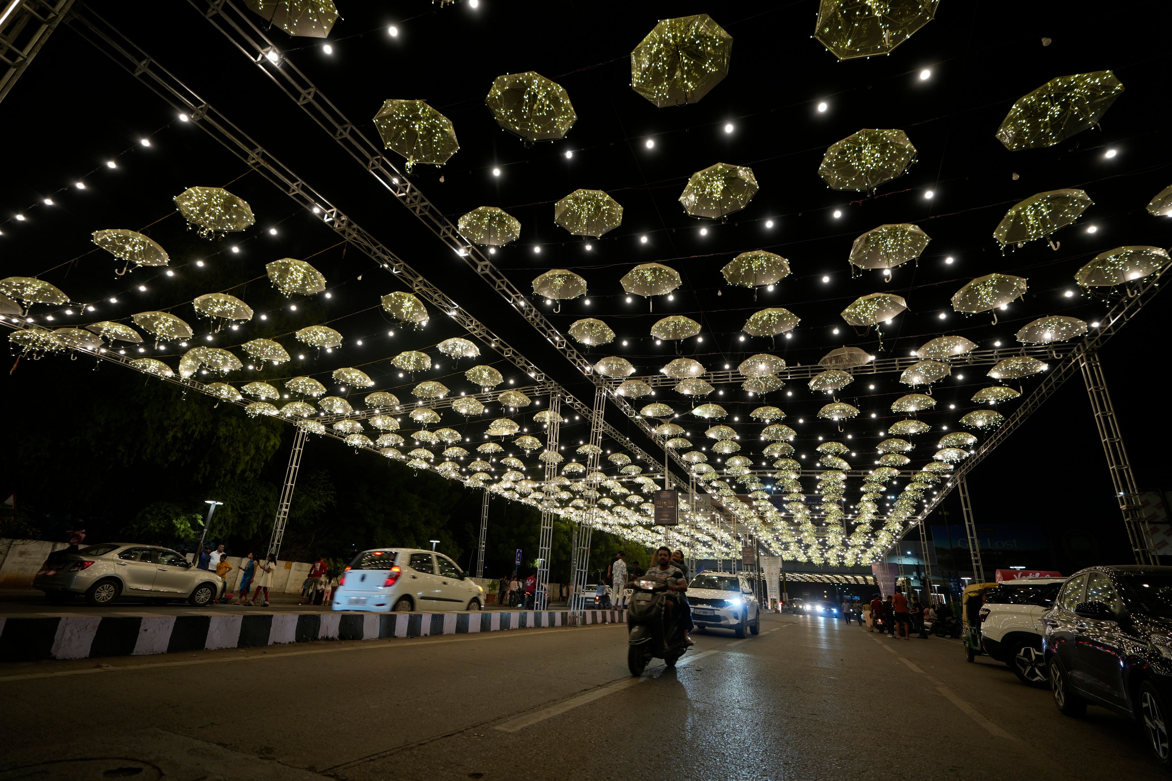 Commuters move on an illuminated road at the Hindu festival of lights Diwali in Ahmedabad, India, Thursday, Oct. 31, 2024. (AP Photo/Ajit Solanki)